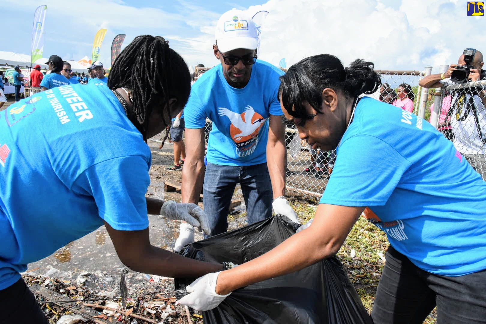 Executive Director of the Tourism Enhancement Fund (TEF), Dr. Carey Wallace (centre), is assisted by TEF officers (from left) Royleta Fraser and Marva Francis, to bag debris collected during a clean-up exercise on International Coastal Cleanup Day , September 21, 2019, on the  Palisadoes  coastline.