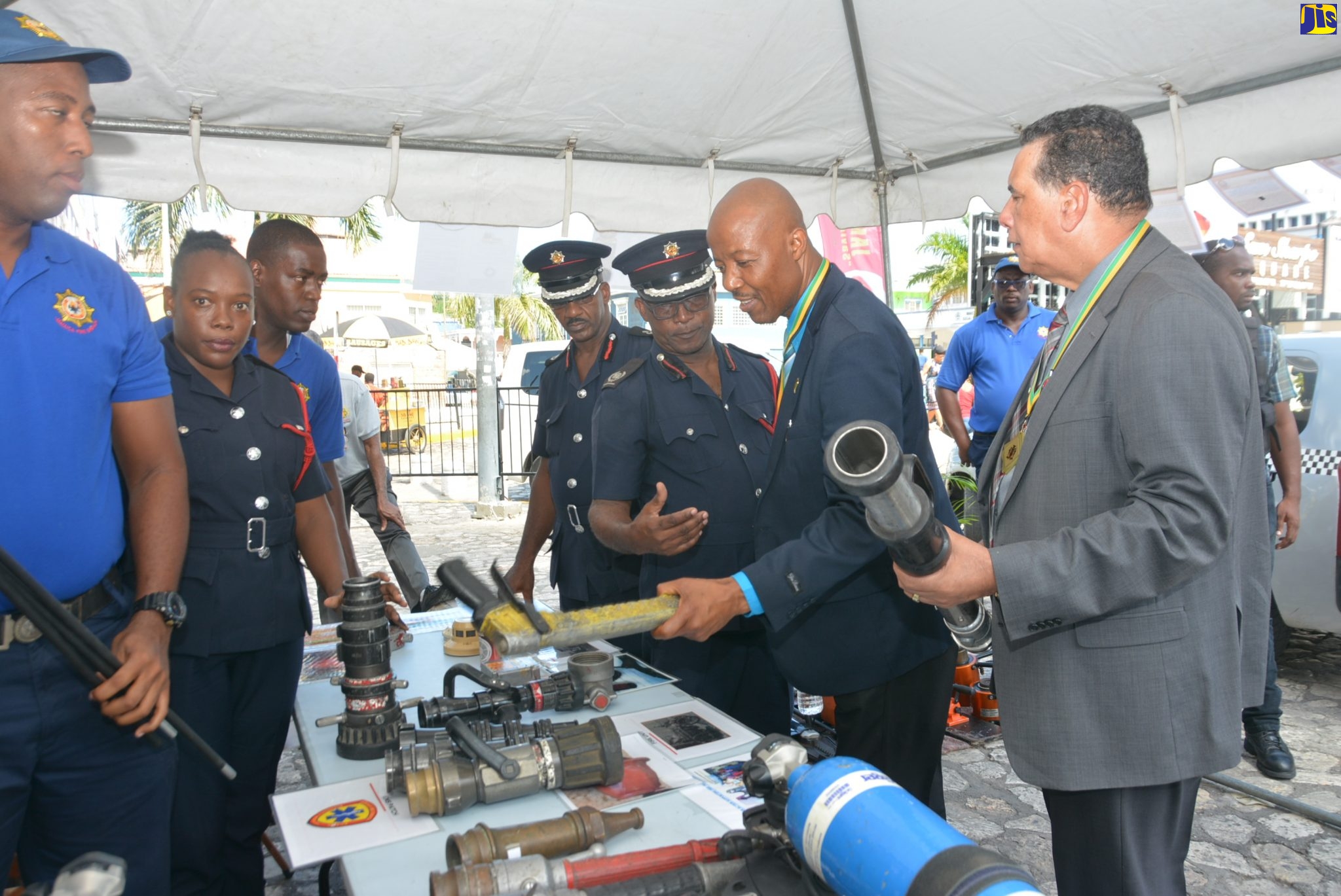 Mayor of Montego Bay, Councillor Homer Davis (right) and Chief Executive Officer of the St. James Municipal Corporation, Gerald Lee (second right), looks at firefighting equipment on display, during the  Jamaica Fire Brigade