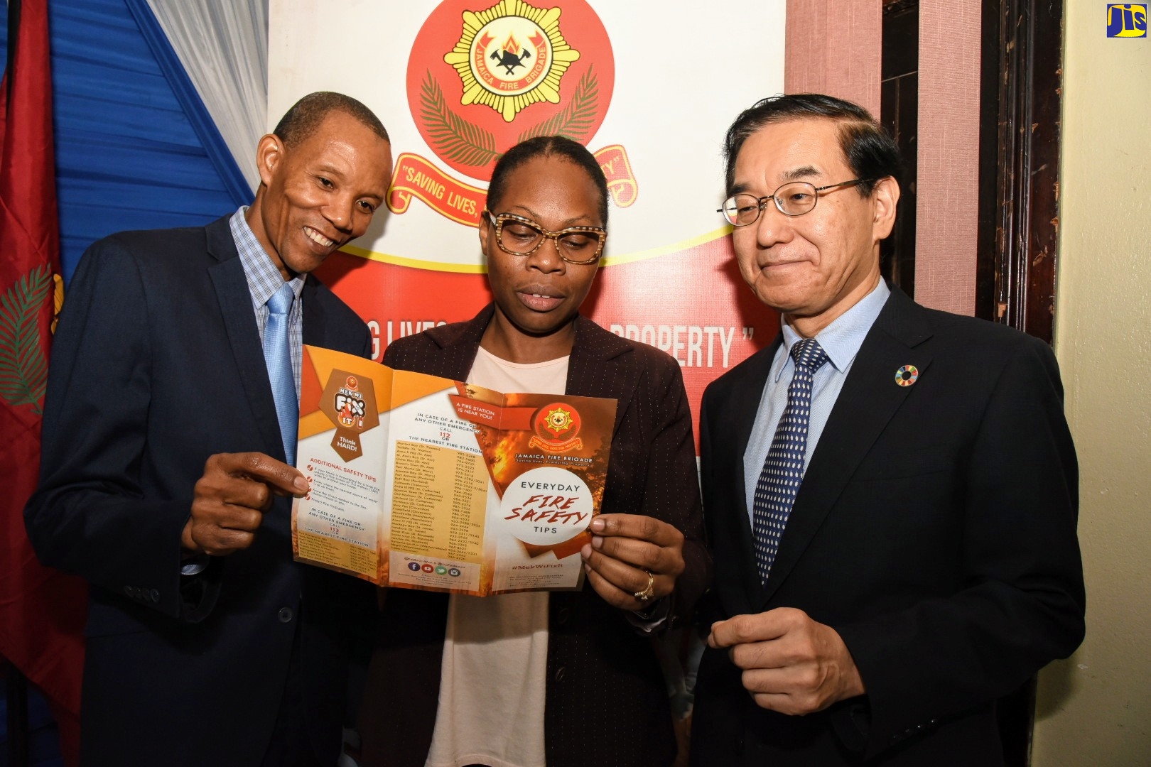 Commissioner of the Jamaica Fire Brigade (FFB), Stewart Beckford (left), peruses a pamphlet containing fire safety tips with Permanent Secretary in the Ministry of Local Government and Community Development, Marsha Henry-Martin, and head of the Japan International Co-operation Agency (JICA) in Jamaica, Takeshi Takano. Occasion was the launch of the JFB’s Fire and Life Safety Awareness Week 2019 at the Police Officers’ Club, St. Andrew on Friday (Oct. 25).
