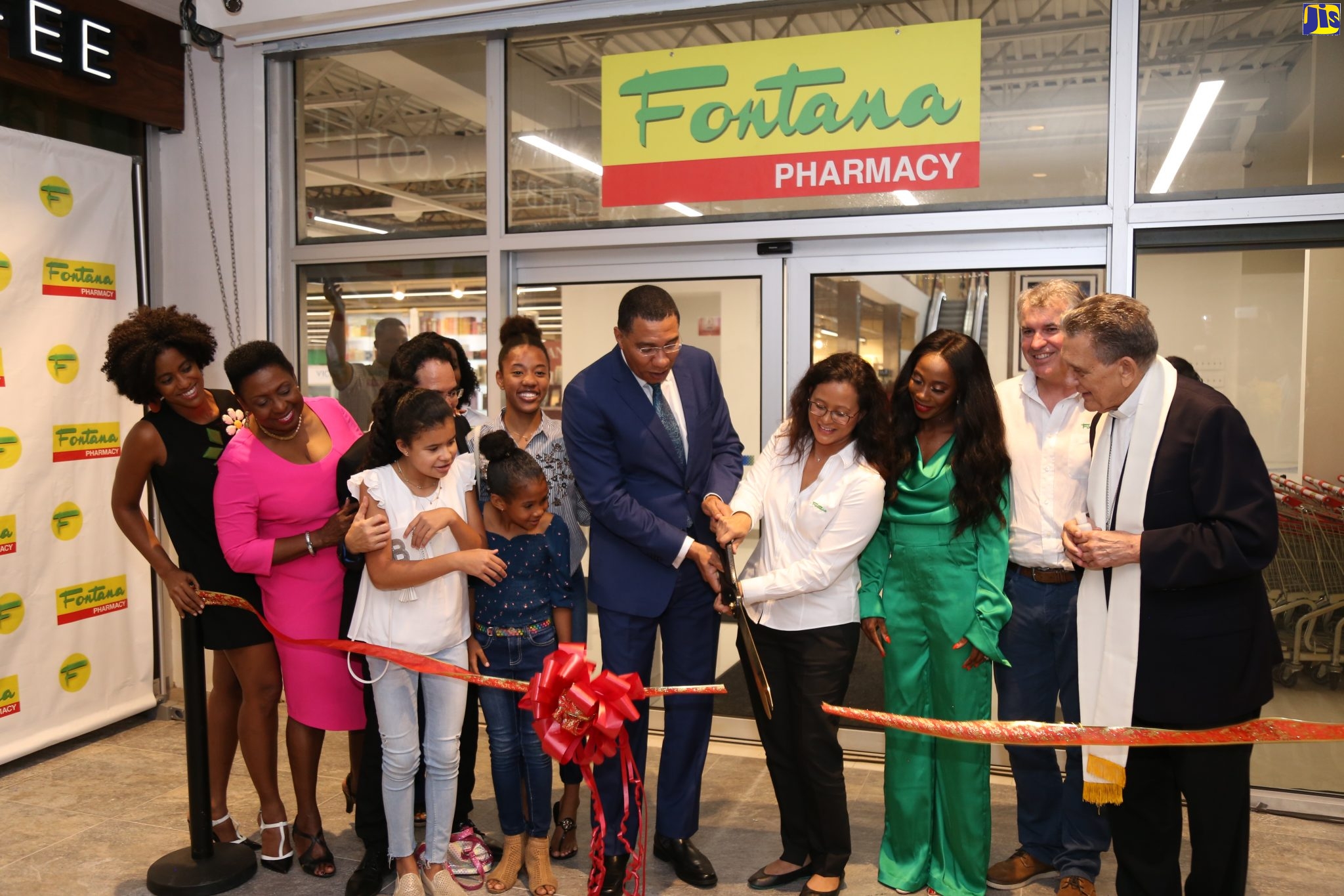 Prime Minister, the Most Hon. Andrew Holness (5th right), and Fontana Pharmacy's Chief Executive Officer, Ann Chang (4th right), cut the ribbon to officially open the pharmacy's Waterloo branch in St. Andrew on Thursday (October 17). Sharing in the moment (from left) are: former Opposition Senator and businesswoman Imani Duncan Price; Minister of Culture, Gender, Entertainment and Sport, Hon. Olivia Grange; Jamaican sprinter, Shelly-Ann Fraser-Pryce; Fontana’s  Chief Operating Officer, Ray Thierren; and Archbishop Emeritus, Most Rev. Charles Dufour.
