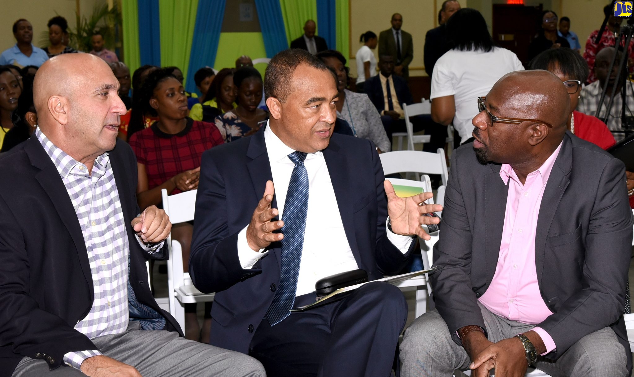 Minister of Health and Wellness, Dr. the Hon. Christopher Tufton (centre), in discussion with (from left) Sagicor Group Jamaica Limited President and Chief Executive Officer, Christopher Zacca, and Senior Vice President for Human Resources and Corporate Services, Karl Williams, during the entity’s mental health symposium hosted at its New Kingston corporate office on Tuesday (October 29). Dr. Tufton was the keynote speaker.