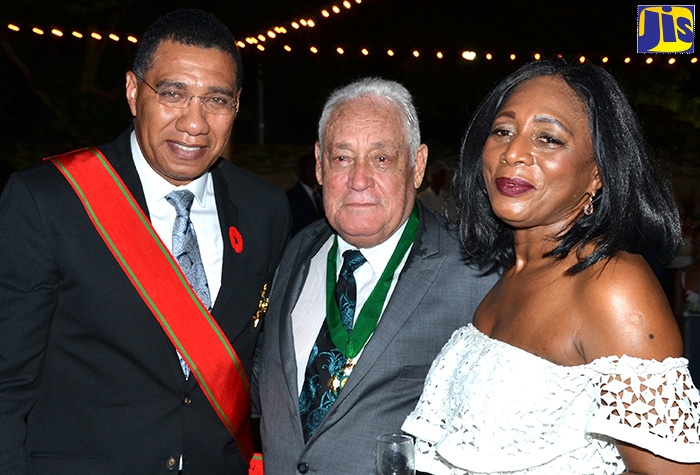 Prime Minister, the Most Hon. Andrew Holness (left), with Minister without Portfolio in the Office of the Prime Minister, Hon. Michael Henry, and his wife, Dawn, at a reception to celebrate Mr. Henry’s Order of Jamaica (OJ) award, which he received at King’s House on October 21. The function was held at The Jamaica Pegasus hotel in New Kingston.
