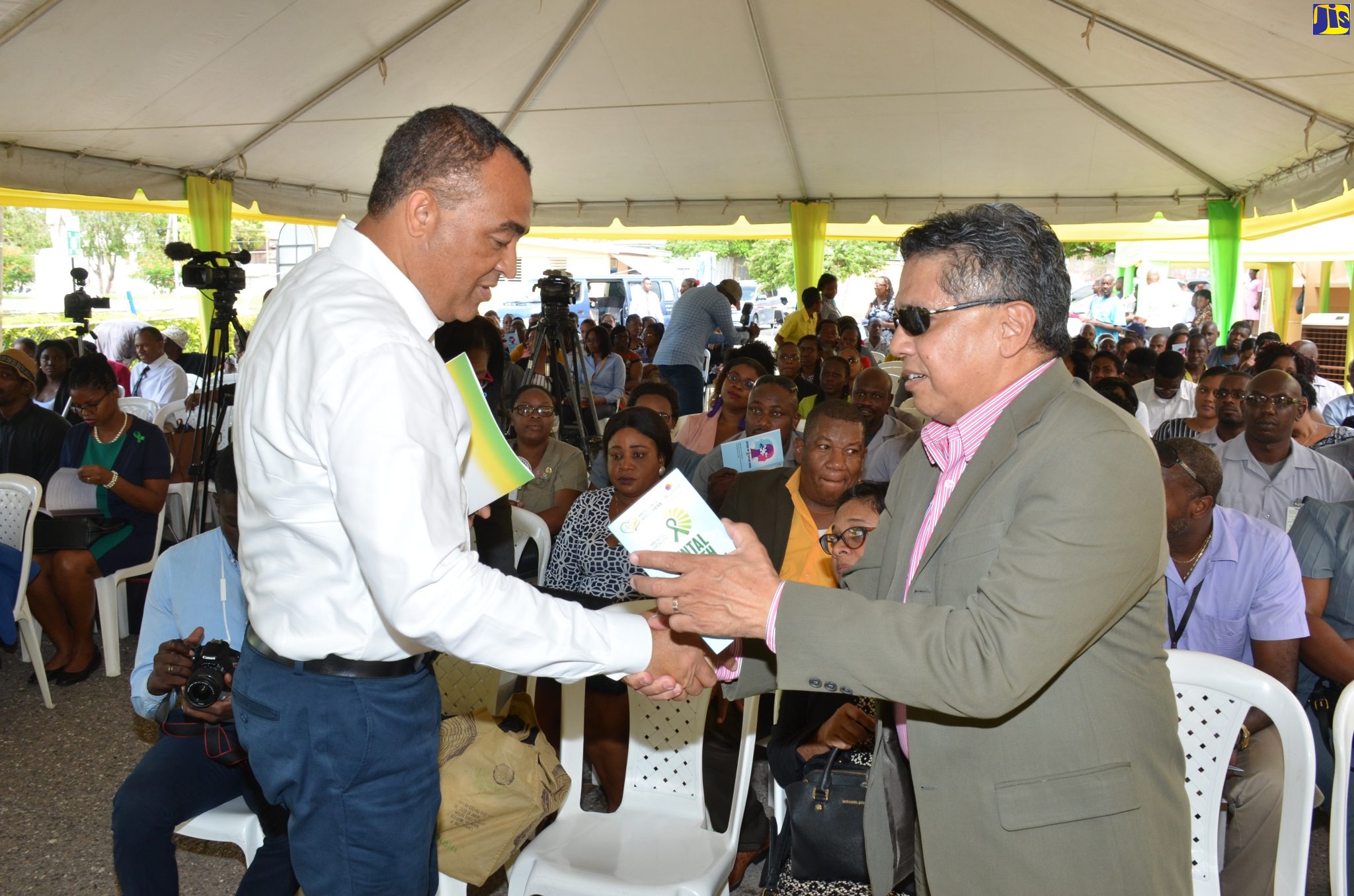 Minister of Health and Wellness, Dr. the Hon. Christopher Tufton (left), is greeted by Board Chairman, Bellevue Hospital, David Wan, upon his arrival at the hospital’s location in downtown Kingston on Thursday (October 10), to participate in the launch of the Ministry’s ‘Speak Up, Speak Now’ mental health campaign.