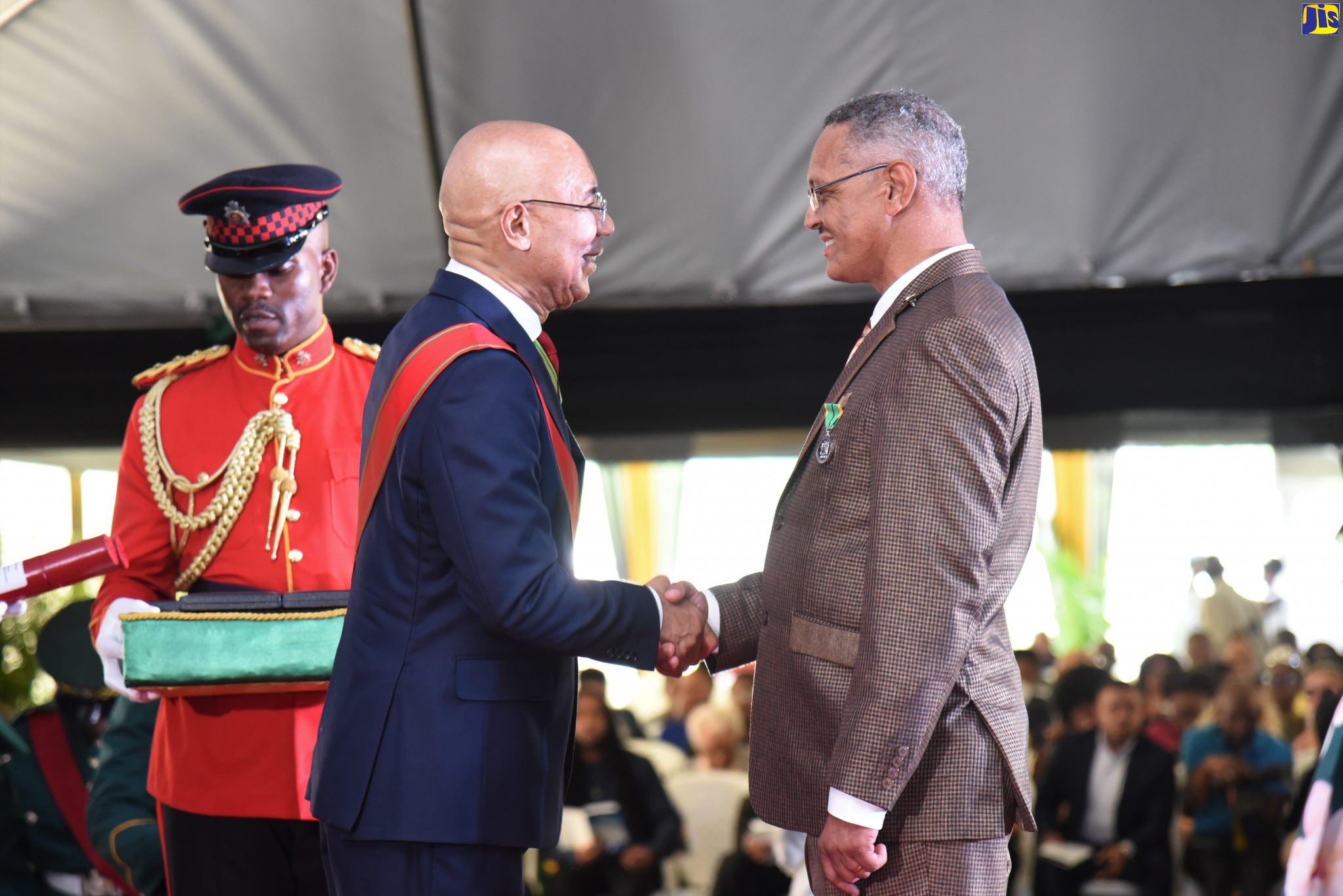 Governor-General, His Excellency the Most Hon. Sir Patrick Allen (centre), presents the Badge of Honour for Long and Faithful Service to Reverend Paul Neil, for service to Religion and Community Service, at the National Honours and Awards Ceremony, held at King's House, on October 21.