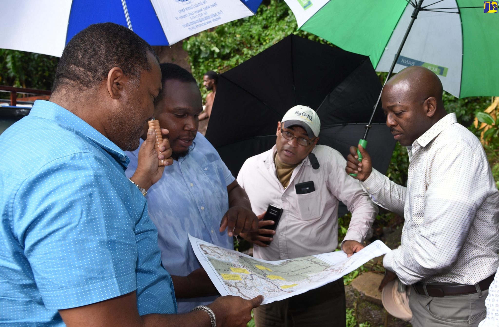 Minister without Portfolio in the Ministry of Economic Growth and Job Creation, Senator the Hon. Pearnel Charles Jr. (right), looks on as Rural Water Supply Limited (RWSL) Engineer, Paul Cummings (2nd left), points out details on a map of water catchment areas in St. Mary. Others (from left) are: Mayor of the parish, Councillor Richard Creary; and RWSL board member, Peter Clarke. Occasion was a tour of RWSL supply systems in the parish on Thursday (Oct. 24).