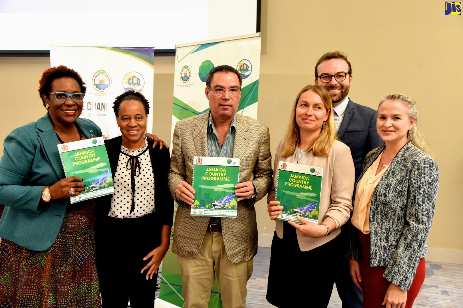 Minister without Portfolio in the Ministry of Economic Growth and Job Creation, Hon. Daryl Vaz (third left), dispplays the document detailing Jamaica’s first Country Programme for engagement with the Green Climate Fund (GCF). He is joined by (from left) Principal Director, Climate Change Division, Ministry of Economic Growth and Job Creation, UnaMay Gordon; Climate Finance Advisor, Climate Change Division, Katherine Blackman; Director, Climate Change Analytics Inc., Laetitia De Marez; and Deputy Director, Climate Change Analytics Inc., Frances Fuller. In the background is Implementation Specialist, Climate Change Analytics Inc., Paolo Cozzi. The Country Programme will enhance the country’s capacity to access more financing for projects dealing with climate change. Minister Vaz launched the programme during the opening of a national consultation on climate action at the AC Marriott Kingston Hotel, St. Andrew, on Wednesday (October 23).