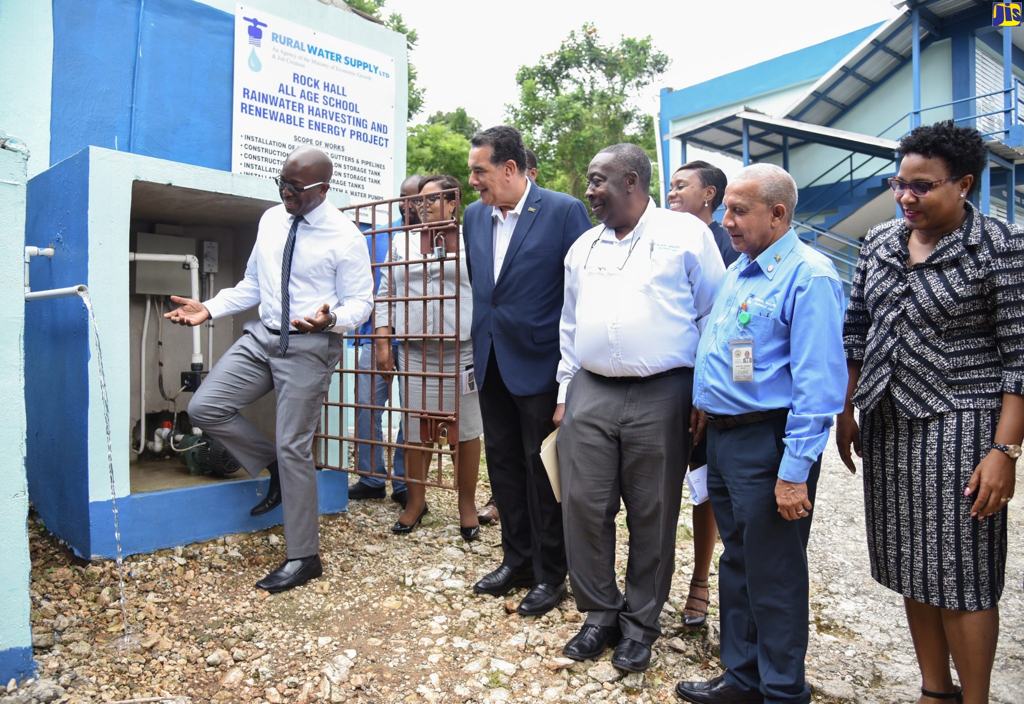 Minister without Portfolio in the Ministry of Economic Growth and Job Creation, Senator the Hon. Pearnel Charles Jr. (left), is delighted to commission a $9-million rainwater harvesting system at the Rock Hall All-Age School in West Rural St. Andrew on October 1. Sharing the moment (from second left) are Education Officer at the Ministry of Education, Youth and Information, Latoya Johnson; Chairman of the Rural Water Supply Limited (RWSL), Councillor Homer Davis, who is also Mayor of Montego Bay; Managing Director of the RWSL, Audley Thompson; Board member of the agency, Councillor Winston Maragh, who is also Mayor of May Pen; and Principal of the school, Paula Plummer.  In the background is Member of Parliament for the area, Juliet Cuthbert-Flynn.