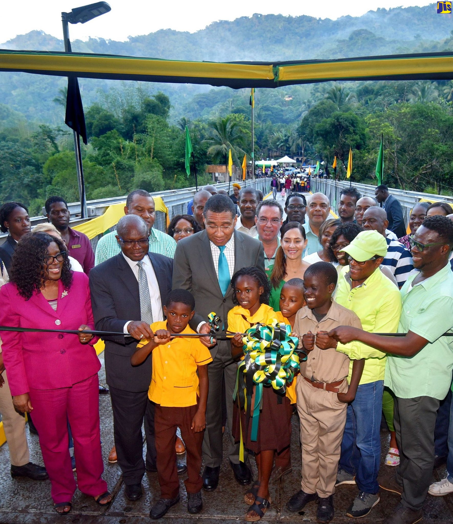 Prime Minister, the Most Hon. Andrew Holness (third left, second row), cuts the ribbon to symbolise the official opening of the Chesterfield Bridge in St. Mary during a ceremony on Wednesday (October 16). Also pictured (from left, second row) are: Permanent Secretary in the Office of the Prime Minister and Ministry of Economic Growth and Job Creation, Audrey Sewell; Minister of State in the Office of the Prime Minister with responsibility for Works, Hon. Everald Warmington; Member of Parliament for East Portland, Ann-Marie Vaz; and Member of Parliament, St. Mary South Eastern, Dr. Norman Dunn, while in the third row (from second left) are: Mayor of Port Maria, Councillor Richard Creary; and Minister without Portfolio in the Ministry of Economic Growth and Job Creation, Hon. Daryl Vaz.