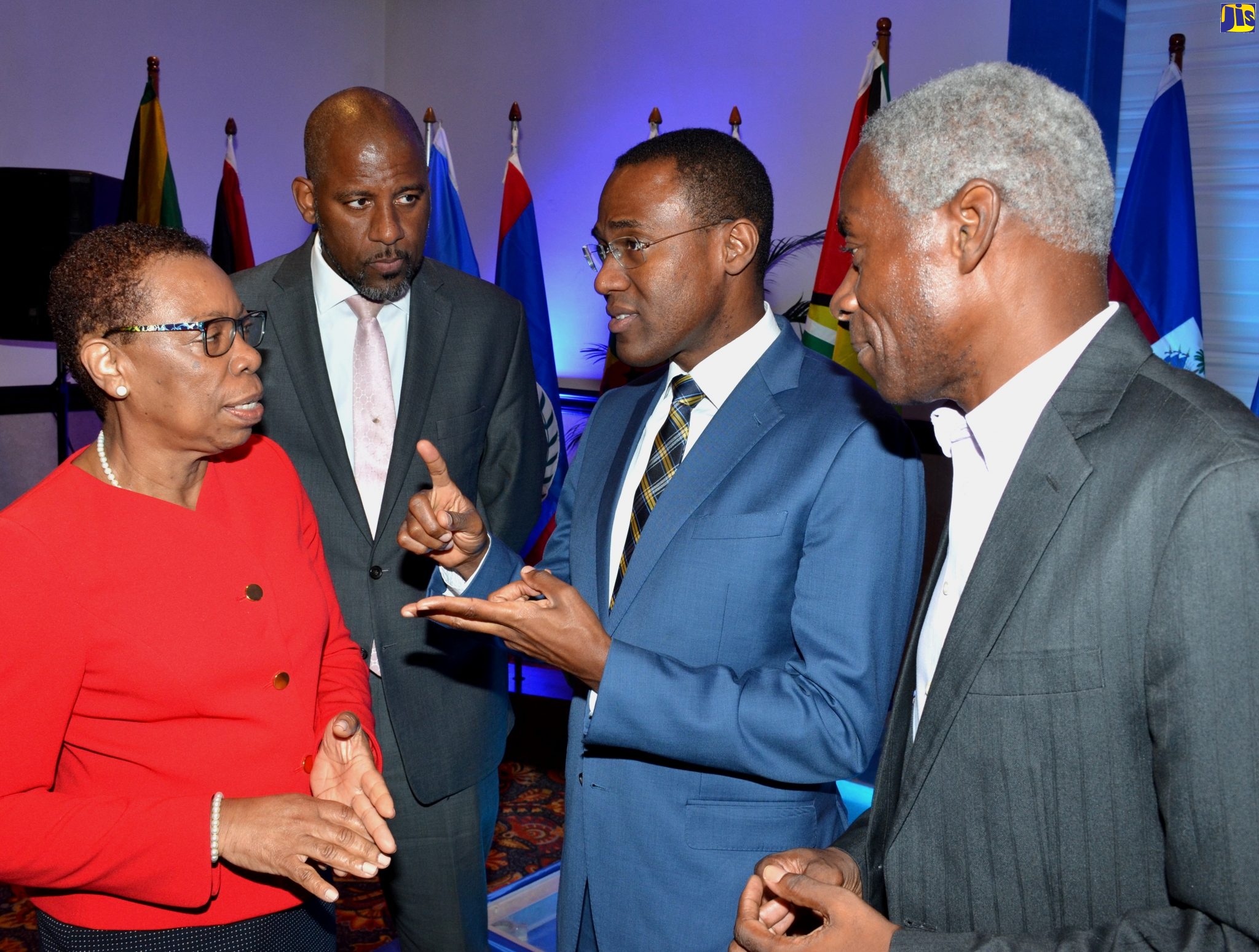 Minister of Finance and the Public Service, Dr. the Hon. Nigel Clarke (second right), emphasies a point to Director General of the Statistical Institute of Jamaica (STATIN), Carol Coy, during the opening ceremony for the 44th Meeting of the Standing Committee of Caribbean Statisticians (SCCS), at The Jamaica Pegasus hotel in New Kingston on Monday (October 28). Also listening (from second left) are Planning Institute of Jamaica (PIOJ) Director General, Dr. Wayne Henry; and STATIN Chauirman, Professor Alvin Wint.