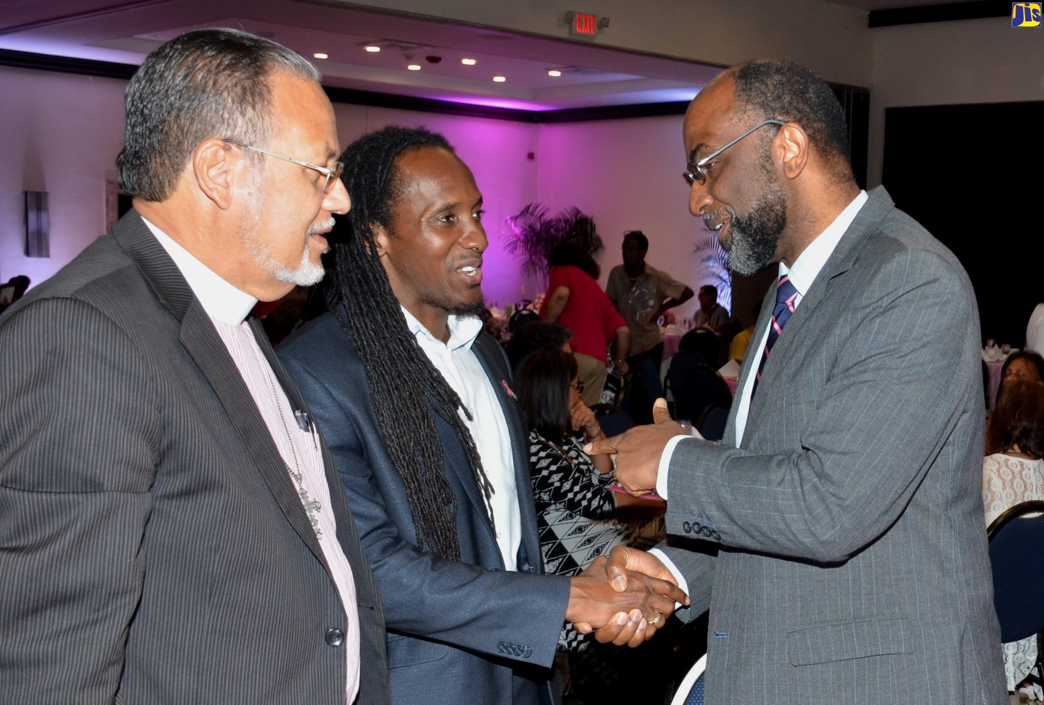 Minister of State in the Ministry of Education, Youth and Information, Hon. Alando Terrelonge (centre), enjoys a light moment with Jamaica Cancer Society (JCS) Chairman, Earl Jarrett (right), during the annual ‘Keeping Abreast’ luncheon held at the offices of the JCS in Kingston on October 24.  Looking on is Superintendent Minister for the Jamaica Methodist District Coke Circuit of Churches, Rev. Bosworth Mullings.The  lucheon, hosted jointly by the JCS and Jamaica Reach to Recovery, forms part of activities marking Cancer Awareness Month during October.