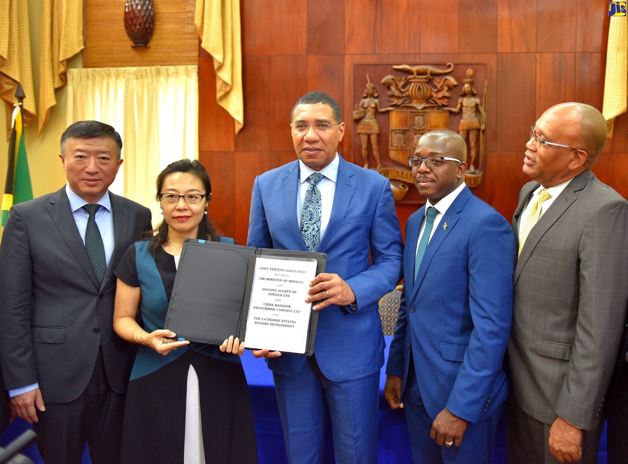 Prime Minister, the Most Hon. Andrew Holness (centre); and President of China Harbour Engineering Company Limited’s (CHEC) Americas Division, Dr. Zhimin Hu (second left), display the signed agreement for the $9.5-billion Catherine Estates housing development in St. Catherine, during a ceremony at Jamaica House on Tuesday (October 15). The project is being implemented under a joint-venture partnership between the Housing Agency of Jamaica (HAJ) and CHEC. Also attending (from left) are Ambassador of the People’s Republic of China to Jamaica, His Excellency Tian Qi; Minister without Portfolio in the Ministry of Economic Growth and Job Creation with responsibility for Housing, Senator the Hon. Pearnel Charles Jr; and HAJ Chairman, Norman Brown.
