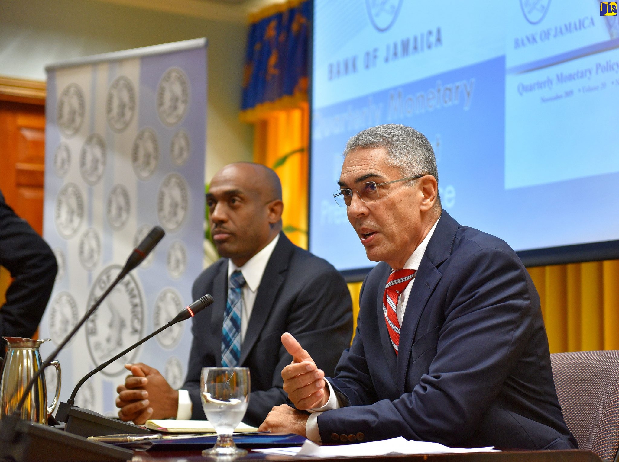 Bank of Jamaica (BOJ) Governor, Richard Byles (right), responds to questions from journalists during Thursday’s (November 21) quarterly briefing, held at the BOJ in downtown Kingston. Listening is Deputy Governor, Dr. Wayne Robinson.