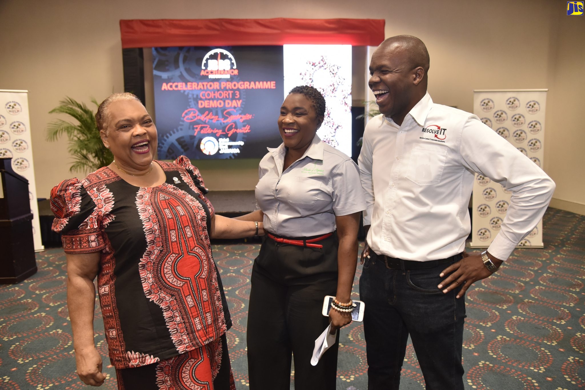 Jamaica Business Development Corporation (JBDC) Chief Executive Officer, Valerie Veria (left), shares a good laugh with entrepreneurs, Treacha Reid-McCalla and Almando Cox, at the JBDC Accelerator Programme’s closing ceremony, held at The Jamaica Pegasus in Kingston, on Thursday, November 21.