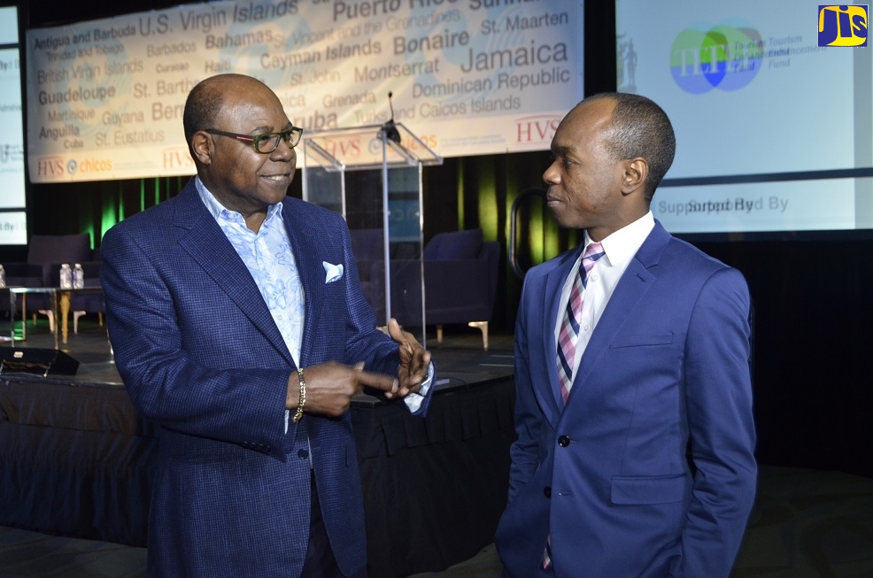 Tourism Minister, Hon. Edmund Bartlett (left), converses with St. Lucia’s Minister of Tourism, Information and Broadcasting, Dominic Fedee, during a Government Leaders panel discussion at the Caribbean Hotel Investment Conference and Operations (CHICOS) Summit at the Secrets Wild Orchard and St. James Resorts in Montego Bay, St. James, on November 15.