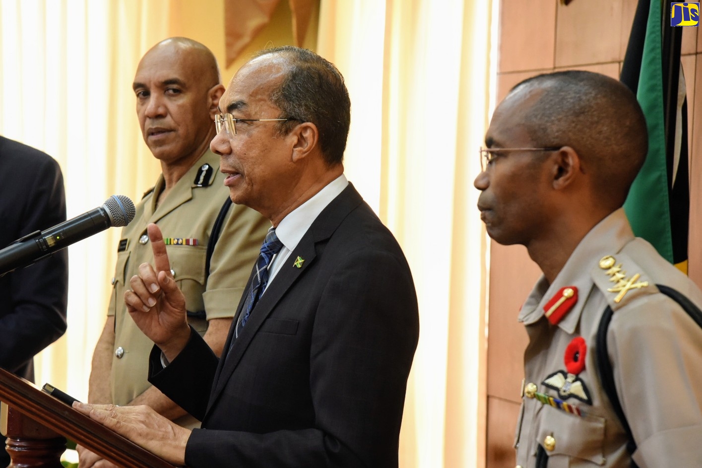 Minister of National Security, Hon. Dr. Horace Chang (centre), emphasises a point while fielding questions from journalists during a press conference at Jamaica House on Thursday (November 7). He is flanked by (from left): Chief of Defence Staff, Lieutenant General Rocky Meade; and Police Commissioner, Major General Antony Anderson.