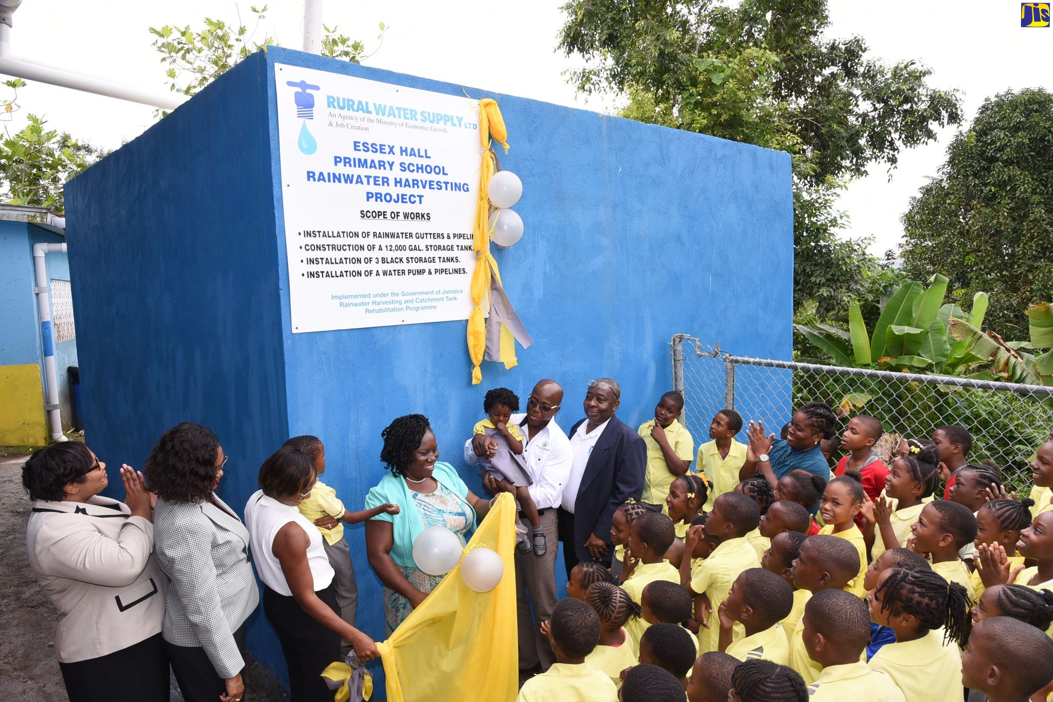 Minister without Portfolio in the Ministry of Economic Growth and Job Creation, Hon. Pearnel Charles Jr (fourth right), celebrates with staff and students of the Essex Hall Primary School at the official handover of a new rainwater harvesting system at  the institution in West Rural St. Andrew last week. The system was installed by the Rural Water Rural Supply Limited (RWSL), which is an agency under the Ministry.