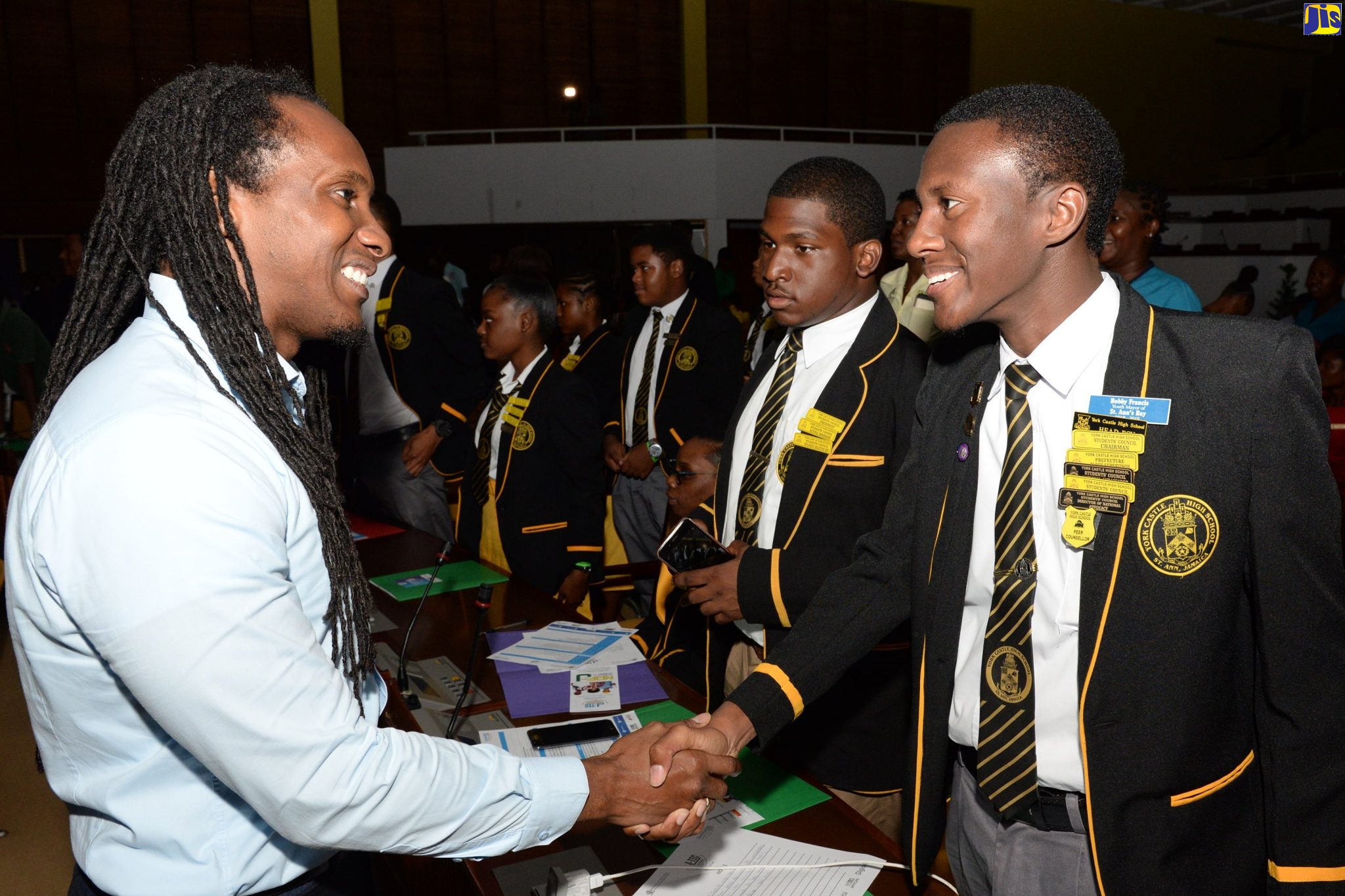 Minister of State in the Ministry of Education, Youth and Information, Hon. Alando Terrelonge (left), greets head boy of York Castle High School in St. Ann, Bobby Francos (right), at the Jamaica Tertiary Education Commission’s (J-TEC) Go Higher Conference on Thursday (October 31) at the Jamaica Conference Centre, downtown Kingston. At second right is President of the Students’ Council at York Castle High, Mark Johnson.