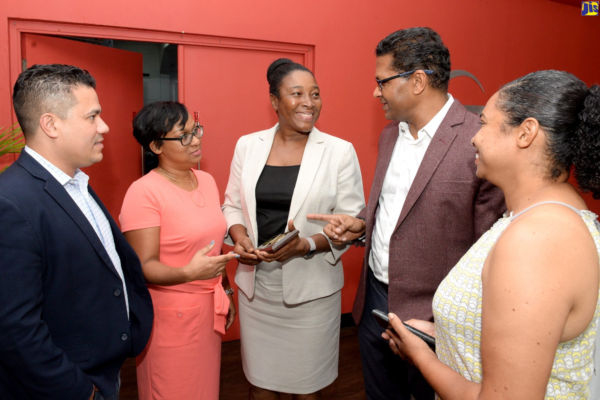 President of the Jamaica Manufacturers and Exporters’ Association, Richard Pandohie (2nd right), shares a thought with lead Auditor, National Certification Body of Jamaica (NCBJ), Yvonne Castel (centre), at a special luncheon to recognise the entity