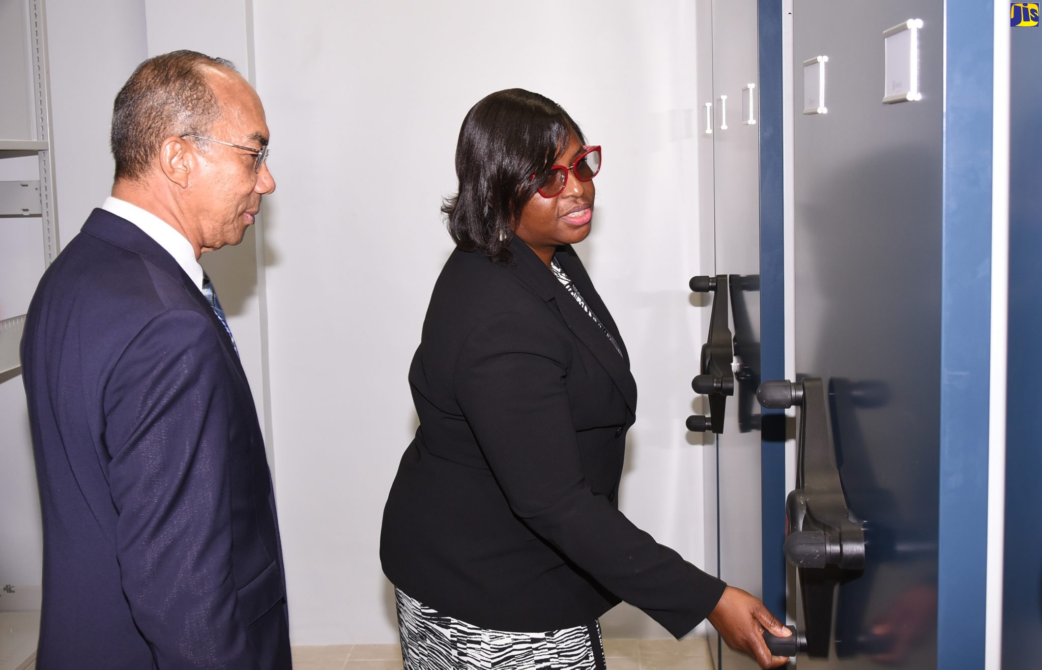 Minister of National Security,  Hon. Dr. Horace Chang (left) and Executive Director, Institute of Forensic Science and Legal Medicine, Dr. Judith Mowatt, view features on the ground floor of the newly built annex at the Institute of Forensic Science and Legal Medicine, during a tour of the facility located at 2½ Hope Boulevard in St. Andrew, on November 27.