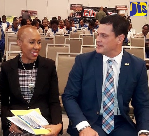 Minister of Science, Energy and Technology, Hon. Fayval Williams (left), converses with Chief Executive Officer and President of the Jamaica Public Service Company, Emanuel DaRosa, at the National Energy Policy's 10th Anniversary Symposium at AC Marriott Hotel in New Kingston on Wednesday (November 27).