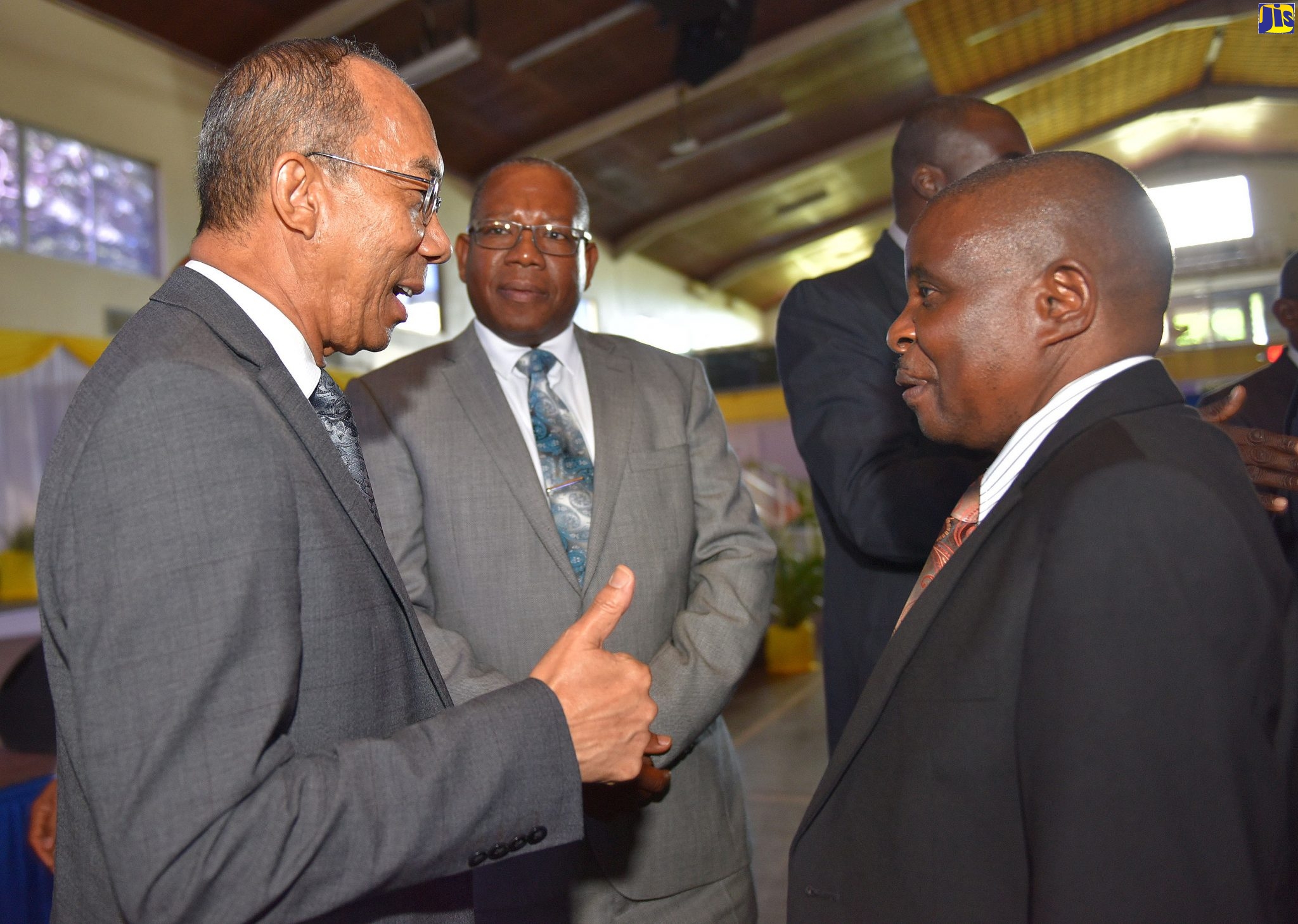 Minister of National Security, Dr. the Hon. Horace Chang (left), converses with President of Northern Caribbean University (NCU), Dr. Lincoln Edwards (centre); and Dean of the School of Religion and Theology, Dr. Simon Bwambale, at the Conference on Religion and Crime Prevention held at the NCU campus in Mandeville on November 26.