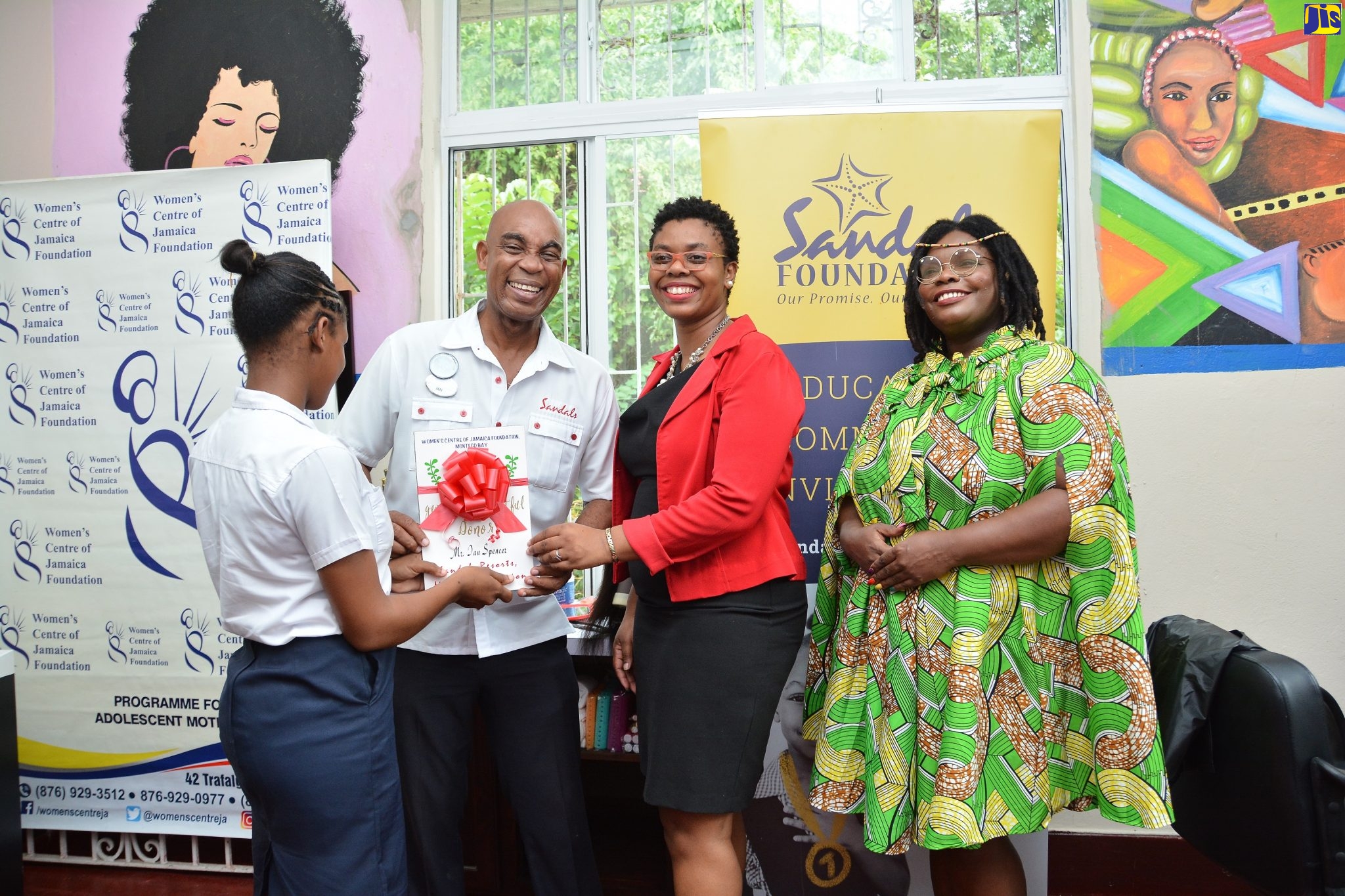 Sandals Foundation Ambassador, Ian Spencer (second left), Public Relations and Communications Manager at the Women’s Centre of Jamaica Foundation (WCJF) Latoya Rattary (second right), and Cosmetology Teacher Rondene Robertson (right), share a moment with a student at the WCJF’s  Montego Bay branch in St. James on Tuesday (November 26).