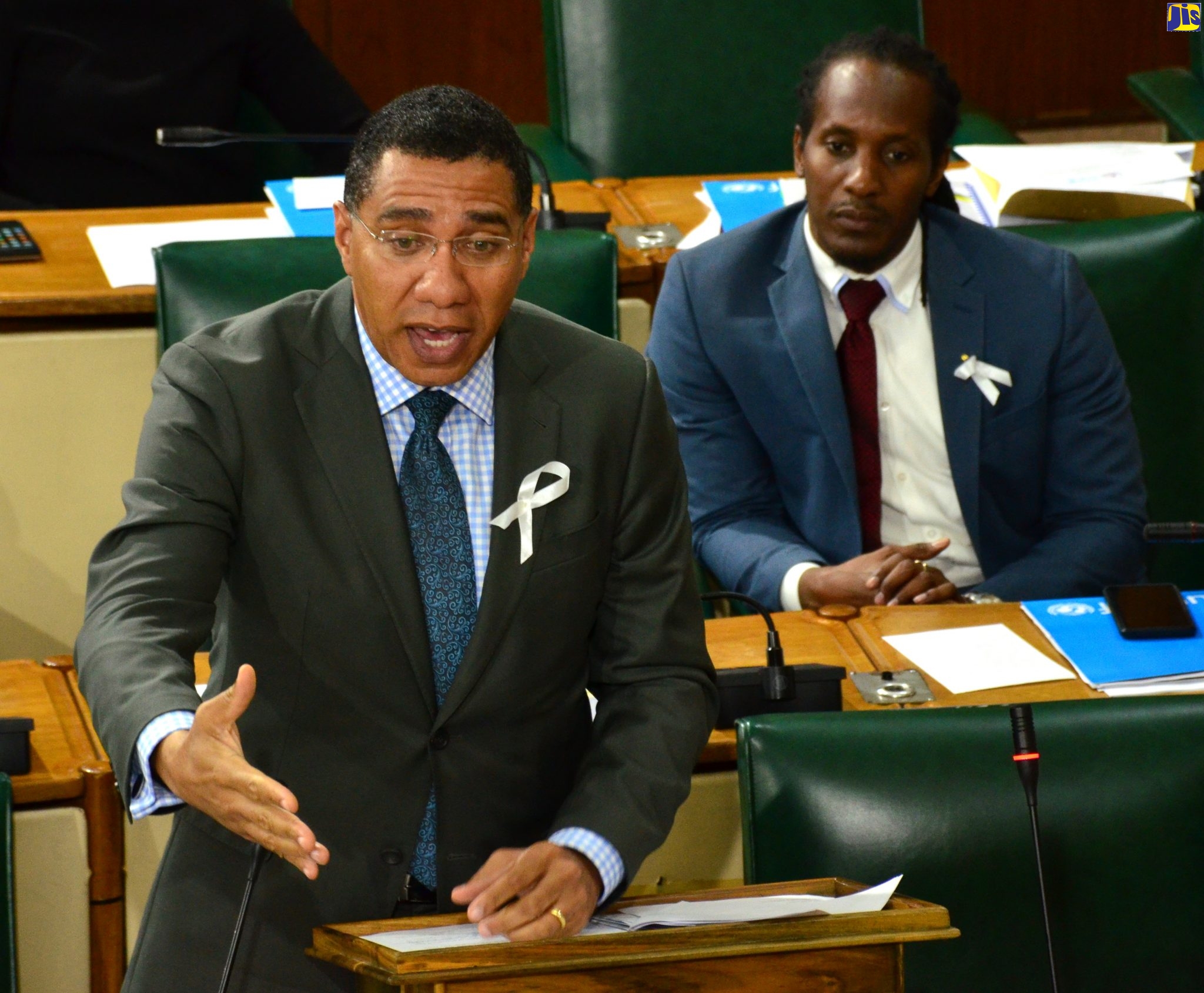 Prime Minister, the Most Hon. Andrew Holness, addresses the House of Representatives on November 19. At right is State Minister in the Ministry of Education, Youth and Information, Hon. Alando Terrelonge.