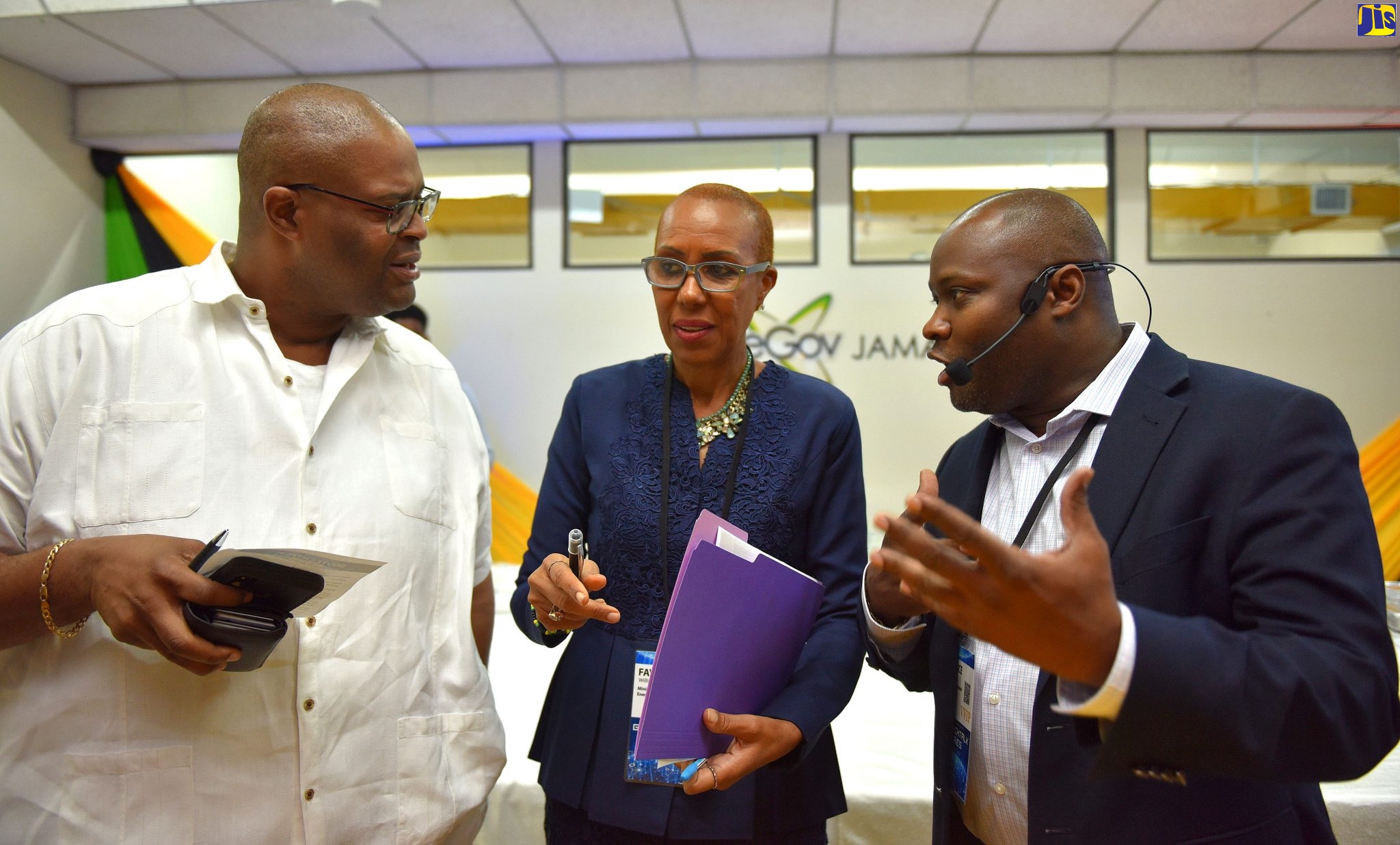 Minister of Science, Energy and Technology, Hon. Fayval Williams (centre), in discussion with  Chairman of eGov Jamaica Limited, Professor Lloyd Waller (left), and Chief Executive Officer of eGov Jamaica Limited, Maurice Barnes, at the launch of GovTech Talk Series, at eGov Jamaica Limited,  in Kingston, on Thursday (November 28).