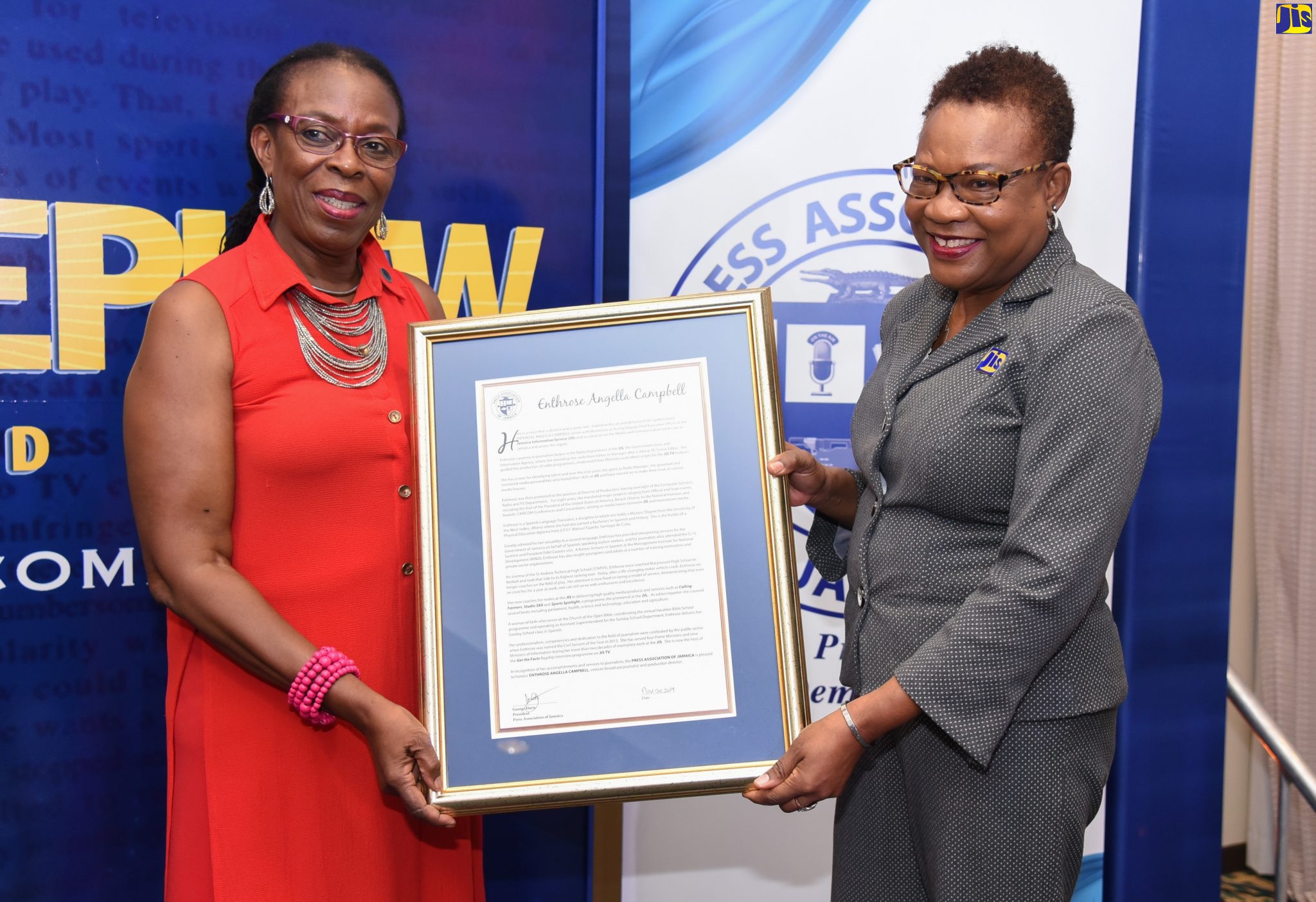 Acting Deputy Chief Executive Officer, Jamaica Information Service (JIS), Enthrose Campbell (right), receives a citation from Director, Press Association of Jamaica (PAJ), R. Christene King,  at the PAJ Veterans’ Luncheon held at the Courtyard by Marriott, New Kingston, on November 20. 