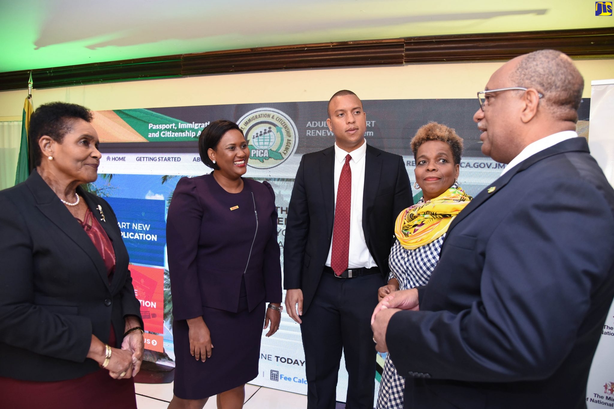 Chief Executive Officer, Passport, Immigration and Citizenship Agency (PICA), Andrew Wynter  (right), converses with (from left) Permanent Secretary in the Ministry of Foreign Affairs and Foreign Trade, Ambassador Marcia Yvette Gilbert-Roberts; Commercial Manager, DHL Express, Michelle Andrew; Senior Vice President, Corporate and Commercial Banking, Scotiabank, Perrin Gayle; and Permanent Secretary in the Ministry of National Security, Dianne McIntosh, at the official launch of the agency’s online adult passport renewal application system, at The Jamaica Pegasus hotel in New Kingston, on December  11.