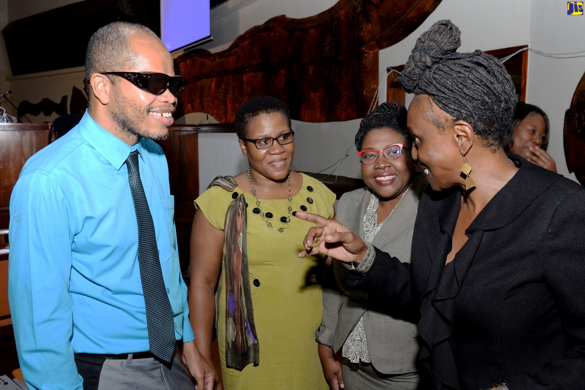 Education Officer, Special Education Unit, Ministry of Education, Youth and Information, Vivian Blake (left), converses with Professor, the City University of New York: Medgar Evers College, Dr. Donna Wright (right), during the Disabilities Awareness Conference, held at the Jamaica Conference Centre in downtown Kingston on December 4. Also participating are (from left) Assistant Chief Education Officer, Special Education Unit in the Ministry, Dr. Sharon Anderson Morgan; and Assistant Chief Education Officer, Media Services, in the Ministry, Nadine Simms.