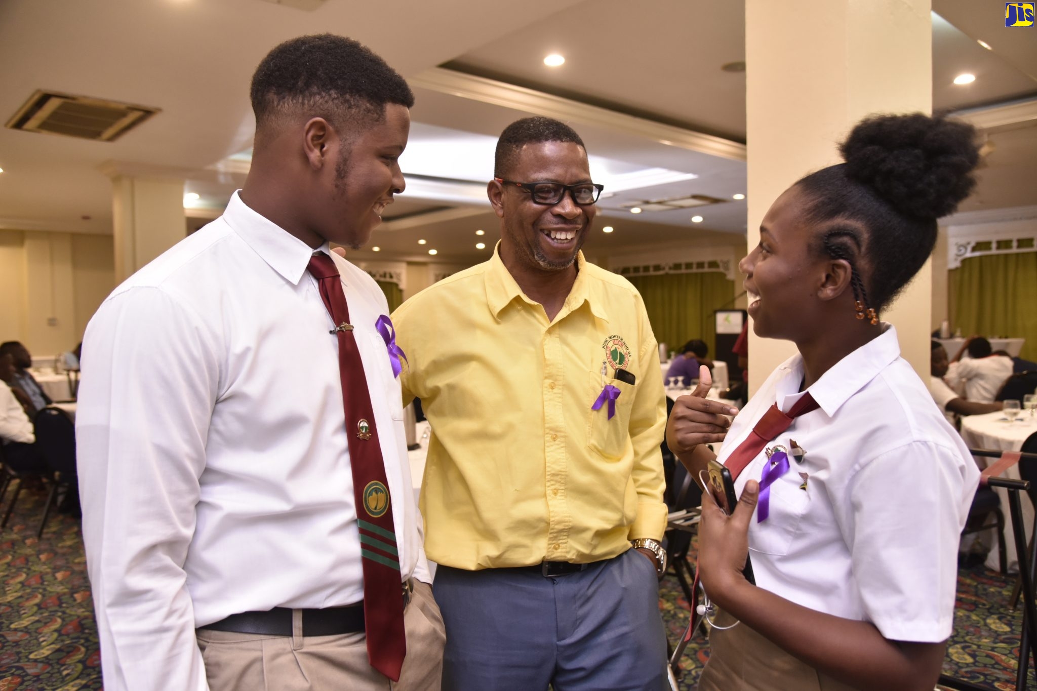 Sixth-form supervisor at Oberin High School in St. Andrew, Everton Leslie (centre), interacting with the school’s head girl, Shanique Bennett and sixth-form student, Rochaun Edwards, at the Stand Up! Talk Up! Youth Conference at The Knutsford Court Hotel in New Kingston on Monday (December 9).