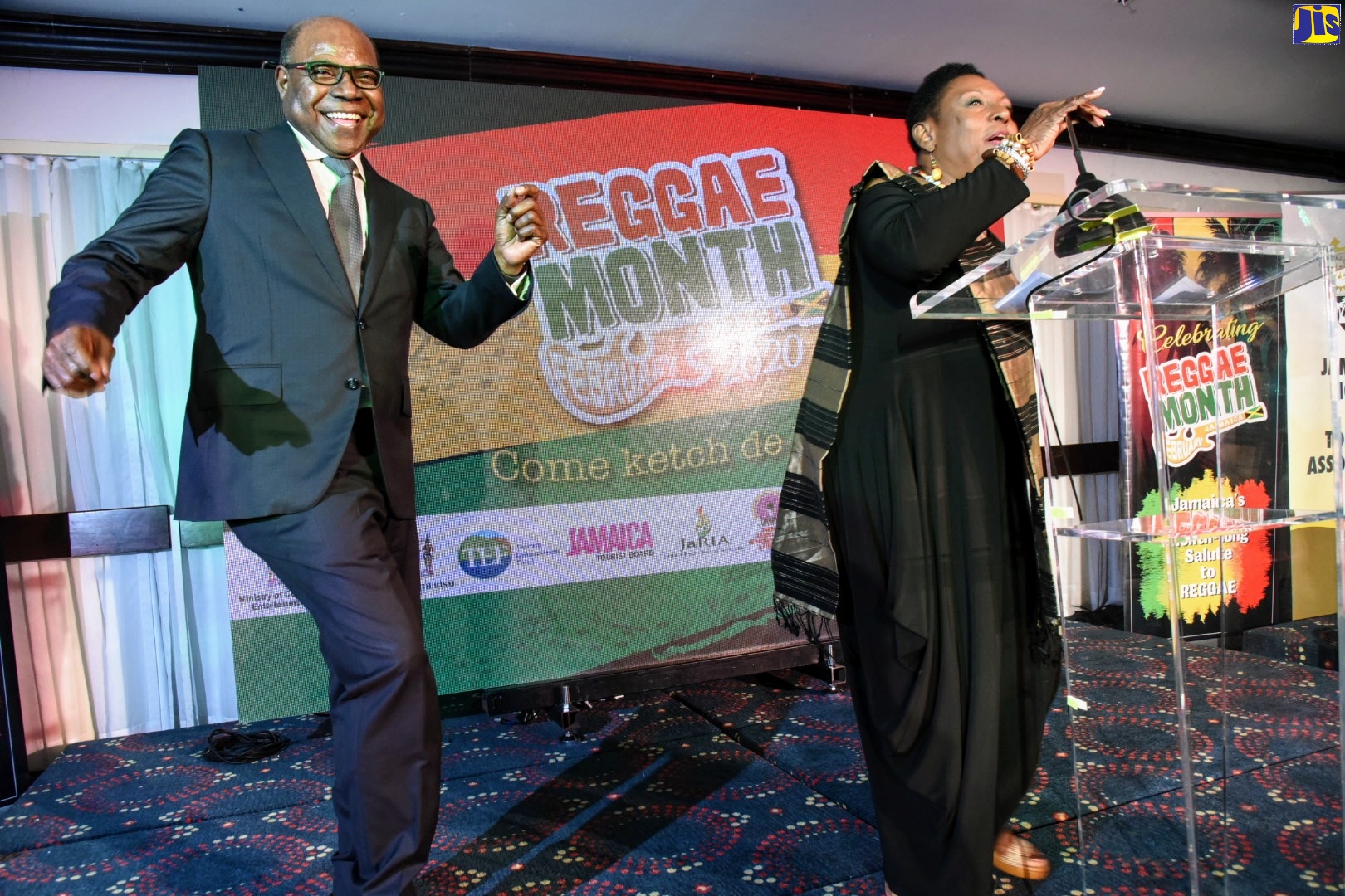 Minister of Tourism, Hon. Edmund Bartlett (left), demonstrates his dancing skills at the invitation of Minister of Culture, Gender, Entertainment and Sport, Hon. Olivia Grange, during Tuesday’s (December 3) media launch of activities to mark Reggae Month 2020, at The Jamaica Pegasus hotel in New Kingston. The events are slated for February 2020 under the theme ‘Come ketch de Riddim’.