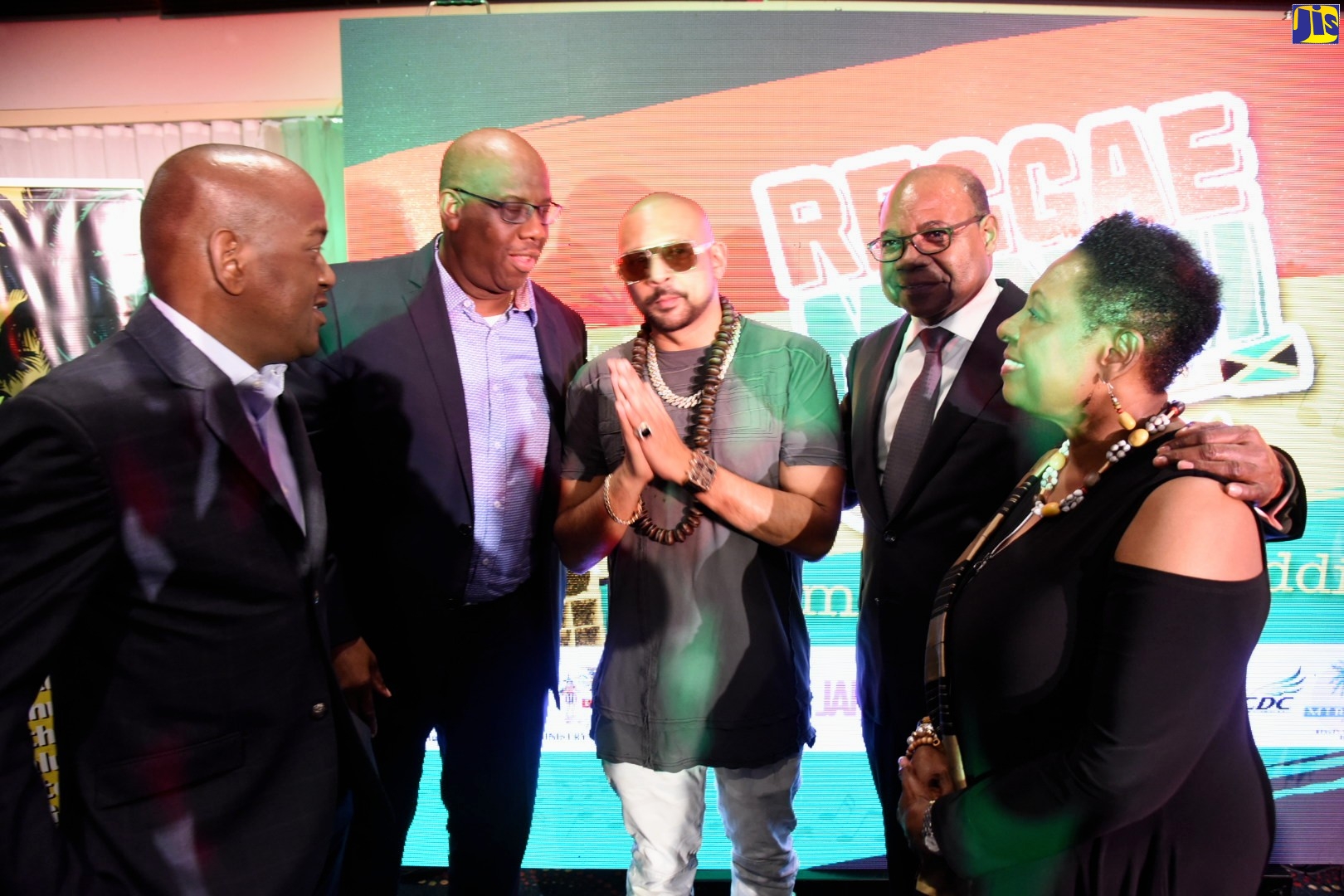 Minister of Culture, Gender, Entertainment and Sport, Hon. Olivia Grange (right), and Minister of Tourism, Hon. Edmund Bartlett (second right), share a moment with Grammy-winning international dancehall artiste, Sean Paul (centre), during Tuesday’s (December 3) media launch of activities to mark Reggae Month 2020, at The Jamaica Pegasus hotel in New Kingston. The events will be held throughout February 2020 under the theme, ‘Come ketch de Riddim’. Others (from left) are Councillor for the Havendale Division of the Kingston and St. Andrew Municipal Corporation (KSAMC), Dwayne Smith, who represented Chairman and Kingston Mayor, Senator Councillor Delroy Williams; and Entertainment Advisory Board Chairman, Howard McIntosh.