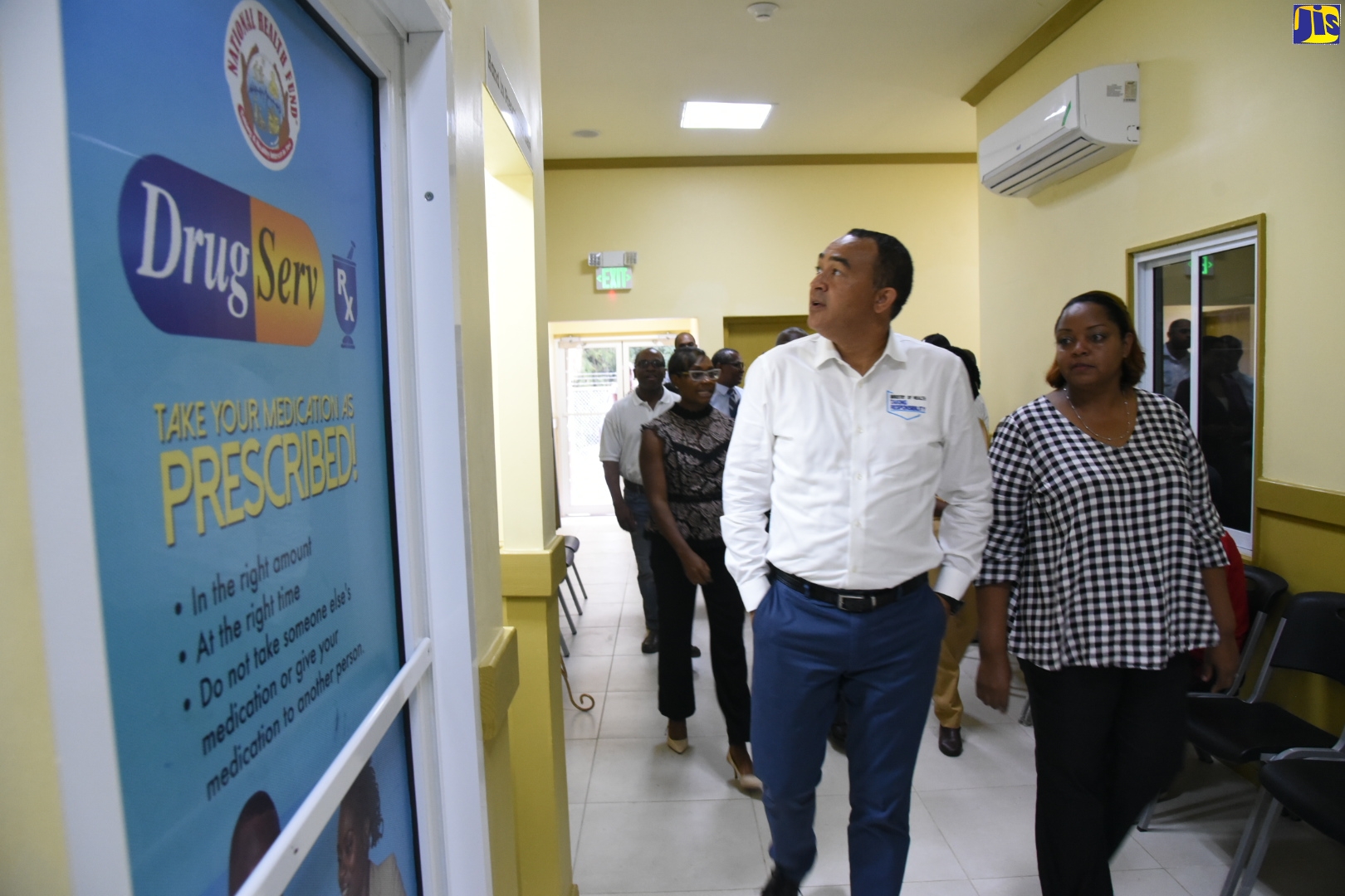 Minister of Health and Wellness, Dr. the Hon. Christopher Tufton and Medical Officer of Health at the Stony Hill Health Centre, Dr. Clivia Baird-Chin, tour the newly renovated and expanded Stony Hill Health Centre, at the reopening ceremony, on December 6. At left (background), is Member of Parliament for West Rural St. Andrew, Juliet Cuthbert-Flynn.