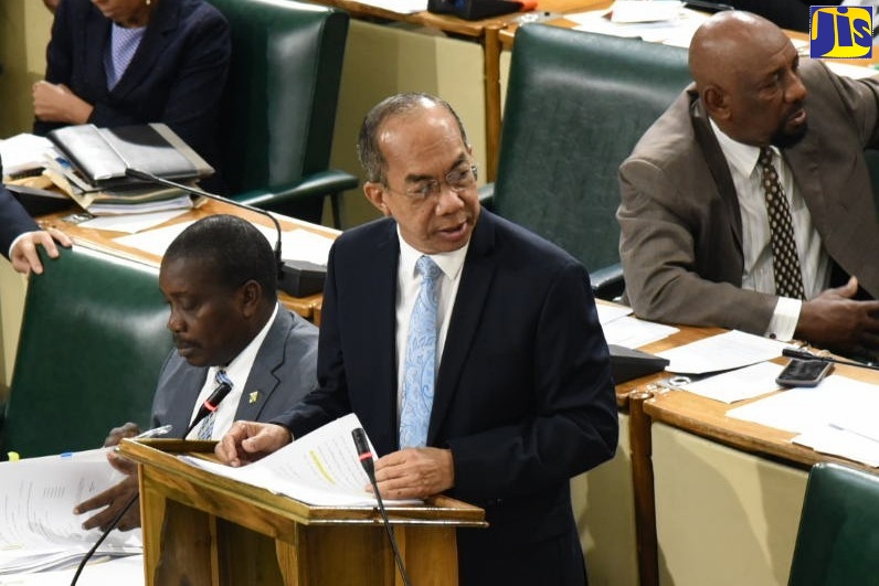 National Security Minister, Hon. Dr. Horace Chang, addresses the House of Representatives on December 10.  With the Minister are Minister of Transport and Mining, Hon. Robert Montague (left), and Minister of State in the Ministry of National Security, Hon. Rudyard Spencer.