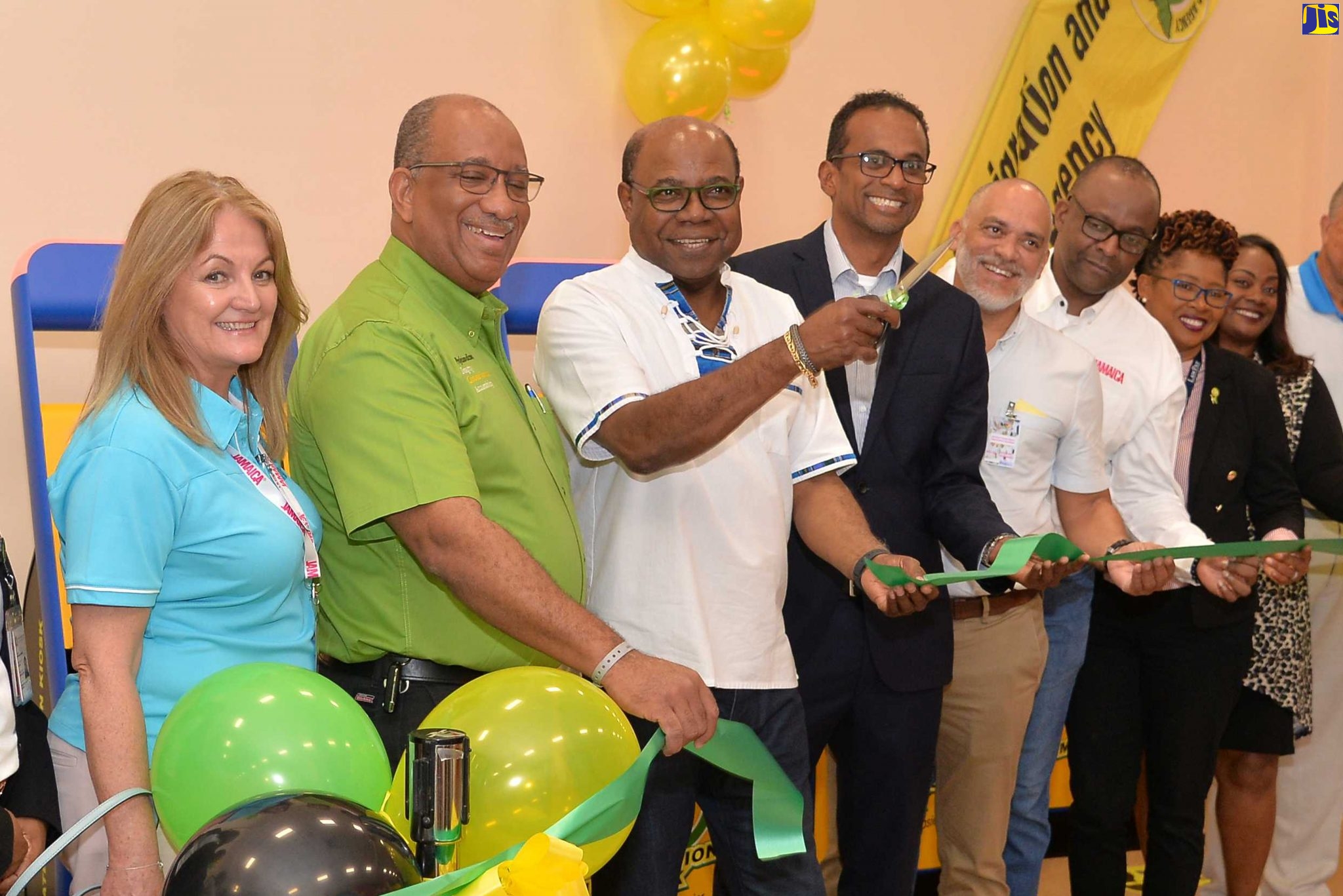 Tourism Minister, Hon. Edmund Bartlett (third left), cuts the ribbon to officially commission 15 new automated immigration kiosks into service at the Sangster International Airport in Montego Bay on December 14. Sharing the moment (from left) are Jamaica Tourist Board (JTB) Regional Director for the United Kingdom/Northern Europe, Elizabeth Fox;  Chief Executive Officer, Passport, Immigration, and Citizenship Agency (PICA), Andrew Wynter; Executive Director, Tourism Enhancement Fund (TEF), Dr. Carey Wallace; President of the Montego Bay chapter of the Jamaica Hotel and Tourist Association (JHTA), Robin Russell; Director of Tourism, Donovon White; Operations Manager for Immigration, Sangster International Airport, Althea Allen-Keene; and  JTB’s Regional Director of Tourism for Canada, Angella Bennett.