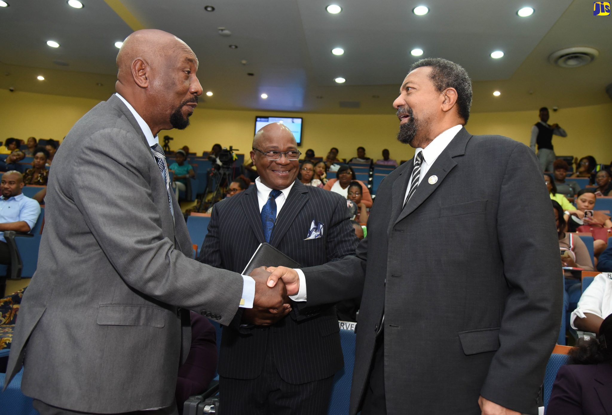 Minister of State in the Ministry of National Security, Hon. Rudyard Spencer (left), greets President and Executive Chancellor, University of the Commonwealth Caribbean (UCC), Professor Dennis Gayle, at the official signing ceremony for a memorandum of understanding (MOU) among the Ministry of National Security through the Department of Correctional Services, Stand Up For Jamaica – a non-governmental organisation and the University of Commonwealth Caribbean (UCC) that will see four inmates and one correctional officer pursuing associate degrees at the UCC. At centre is Commissioner of Corrections, Lieutenant Colonel (retired) Gary Rowe. The signing took place at the UCC’s Worthington Avenue Campus, in St. Andrew, on January  6.