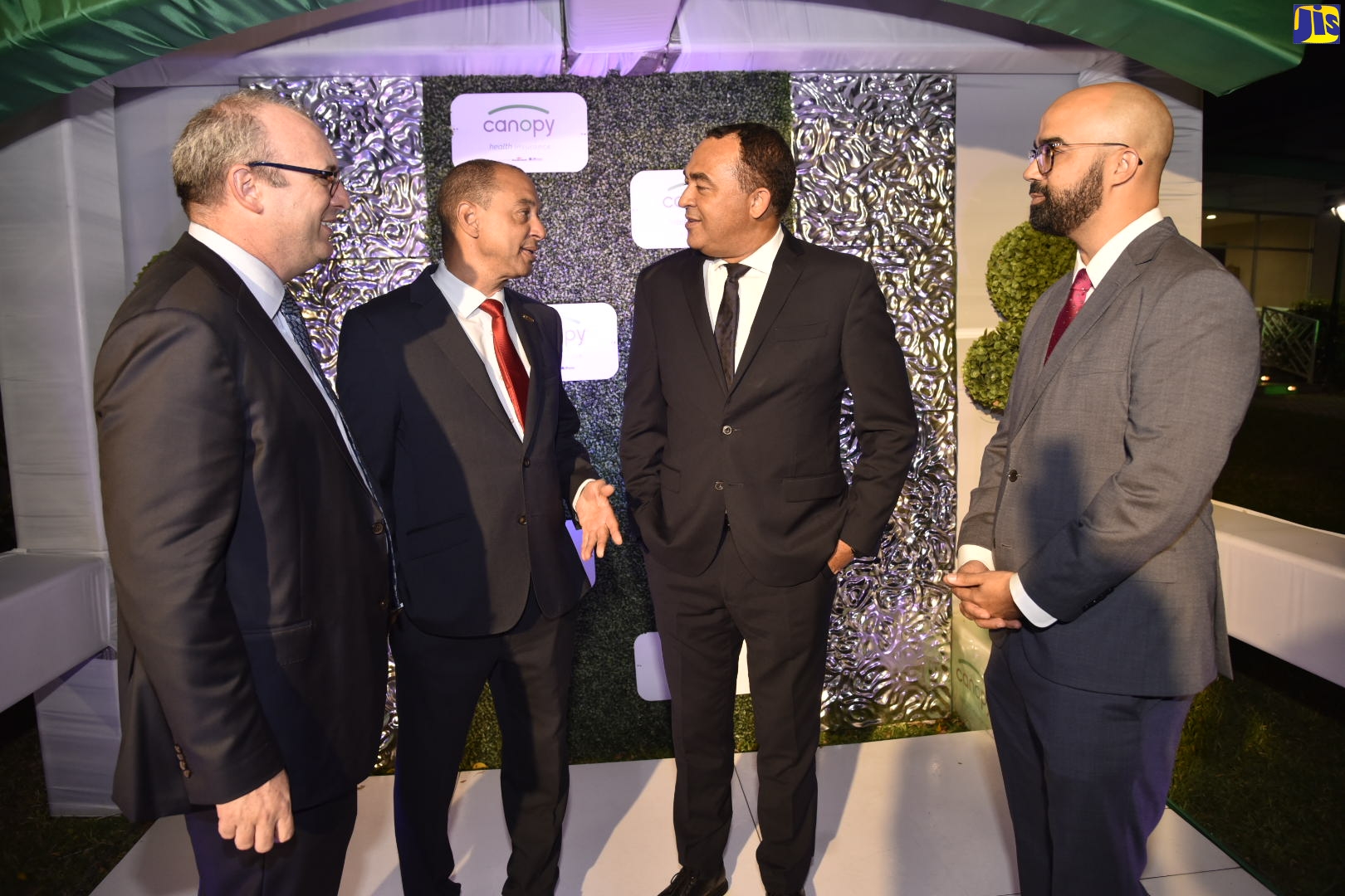 Minister of Health and Wellness, Dr. the Hon. Christopher Tufton (second right), in conversation with Chairman, Canopy Insurance, Senator Don Wehby (second left), at the official launch of Canopy Insurance at The Gardens of The Jamaica Pegasus hotel in New Kingston, on January 16. Others (from left) are Member of Canopy’s Board, Paul Scott; and Managing Director, Canopy Insurance, Sean Scott.
