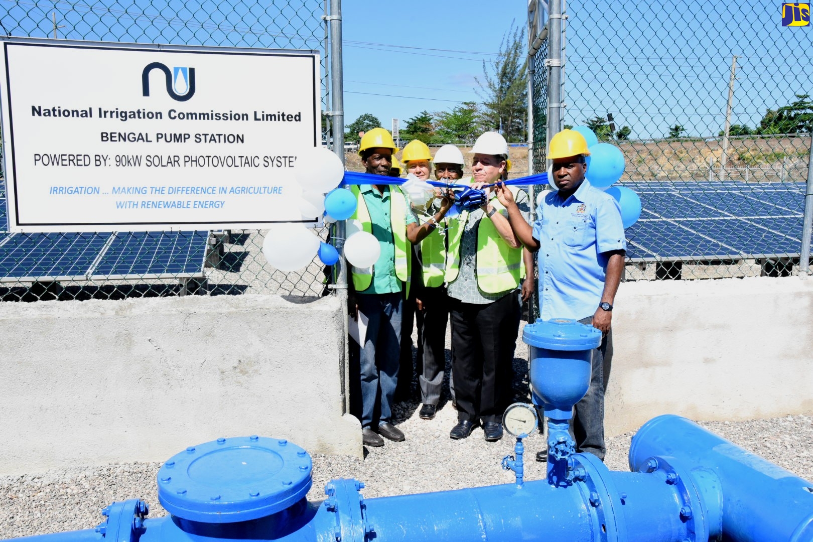 Minister of Industry, Commerce, Agriculture and Fisheries, Hon. Audley Shaw (fourth left), cuts the ribbon to commission into service the Bengal pump station solar system in Rio Bueno, Trelawny, on January 23. Sharing the moment (from left) are Minister without Portfolio in the Ministry of Industry, Commerce, Agriculture and Fisheries, Hon. J.C. Hutchinson; Custos of Trelawny, Paul Muschette; Chairman of the National Irrigation Commission (NIC), Senator Aubyn Hill; and Permanent Secretary in the Ministry, Dermon Spence.