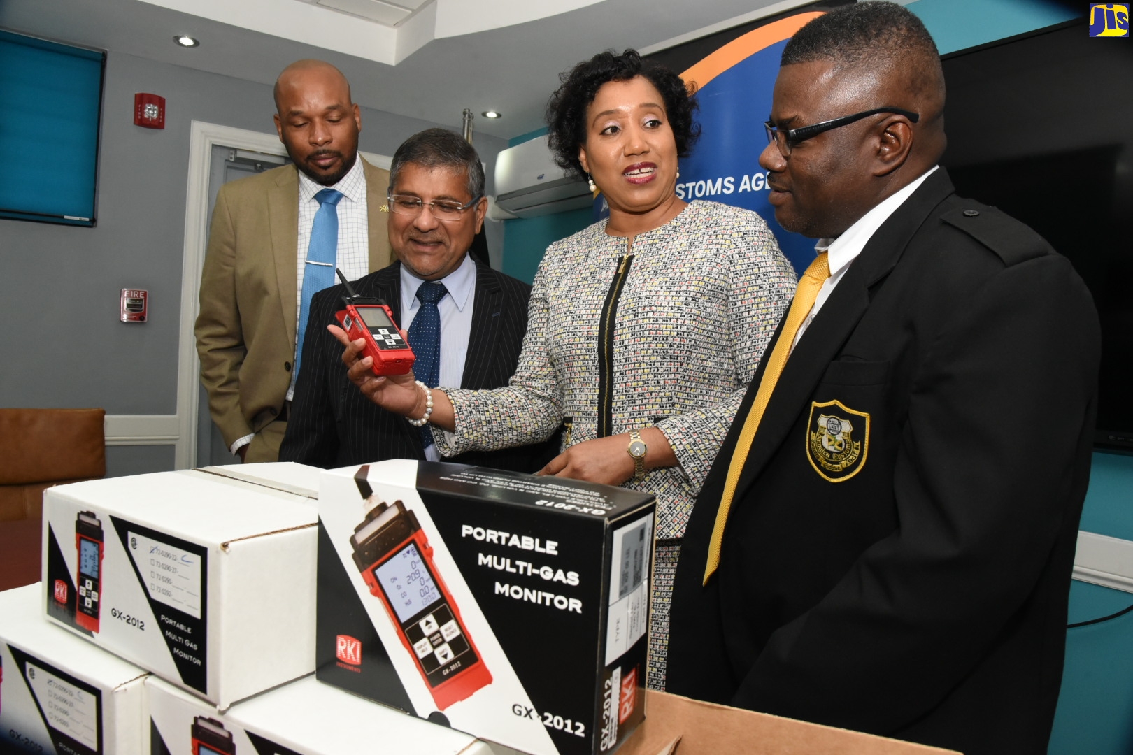 Chief Executive Officer of the Jamaica Customs Agency (JCA), Velma Ricketts Walker (second right) discussing the use of a gas analyser with Deputy Commissioner of Customs, Operations, Marlon Lowe (right), during a handover ceremony at the JCA head office in Kingston on Monday (January 27). Others (from left) are Deputy Commissioner of Customs, Border Protection, Alwyn Nicely; and British High Commissioner to Jamaica, His Excellency Asif Anwar Ahmad. Six gas analysers, which will be used by customs officers to test the air quality inside containers, were donated by the United Kingdom (UK) Border Force.