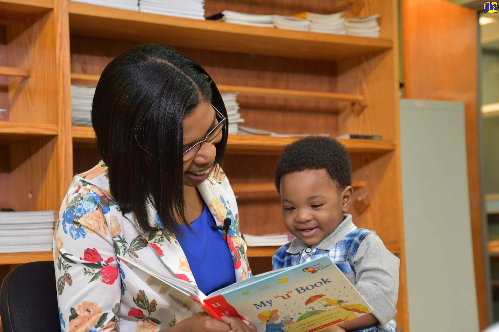 Kedine Matthews Smith reads to her now 10-month-old son, Jonathan, who was diagnosed with dengue fever at six months old.