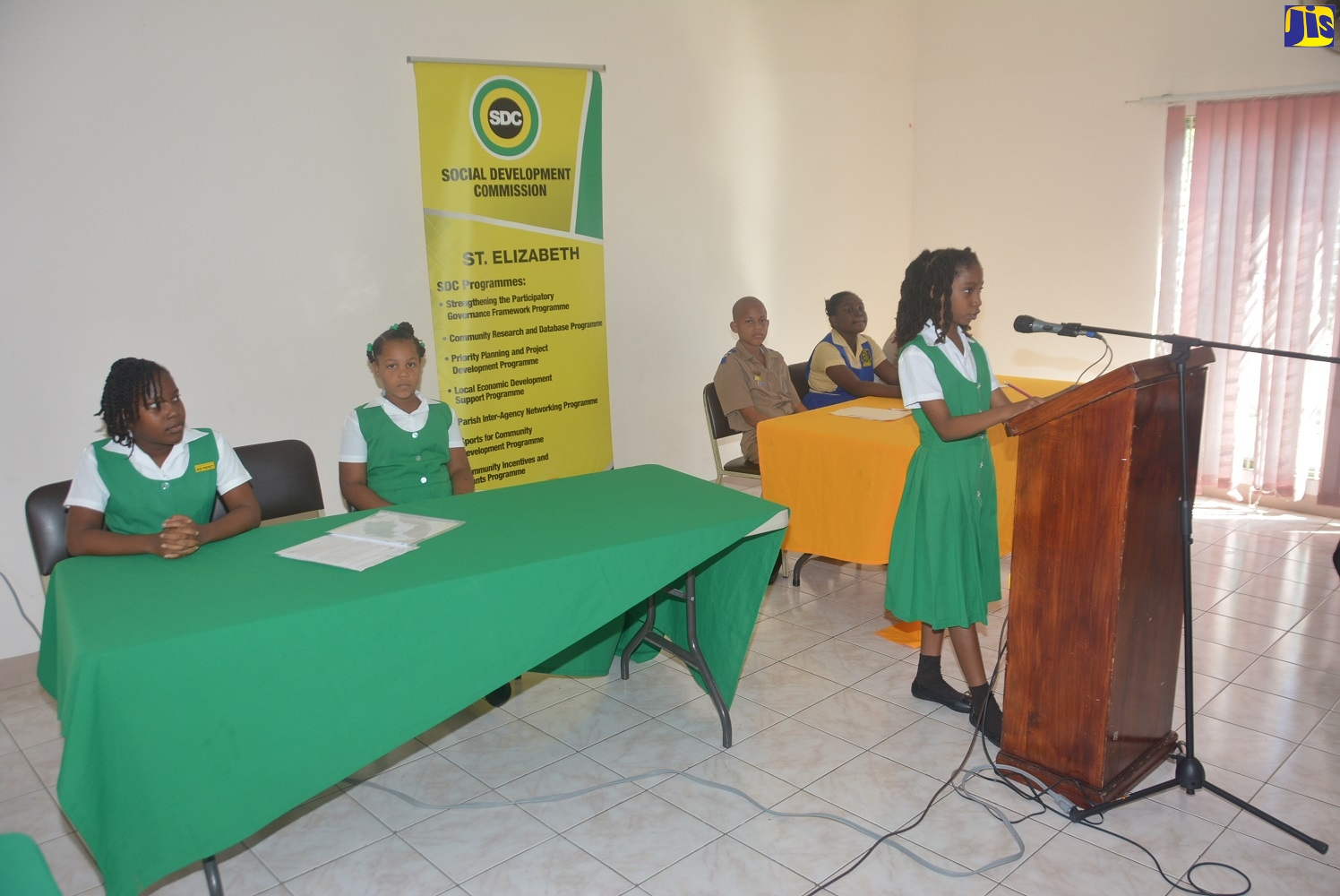 Sandy Bank Primary School student, Aziza Hill (podium), leads her team in debate against Parotee Primary School in Round 1 of the inaugural South West Primary School Debate Competition at the Black River Parish Library in St. Elizabeth on Thursday, January 23.