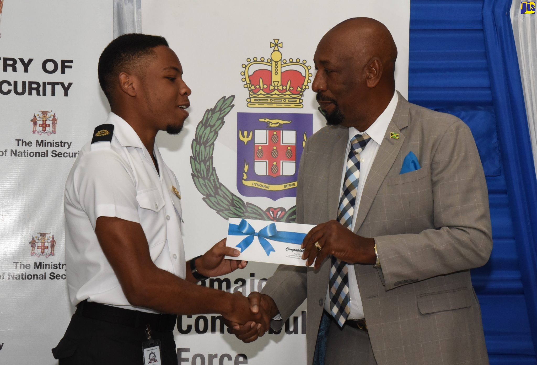 Minister of State in the Ministry of National Security, Hon. Rudyard Spencer (right), presents Tyler Guy, student, Caribbean Maritime University (CMU), with his scholarship letter at the Police Officers’ Club in St. Andrew, on January 15. Occasion was the Ministry of National Security and the Jamaica Police Federation Scholarship Awards Ceremony. A total of 83 students were presented with scholarships during the ceremony.