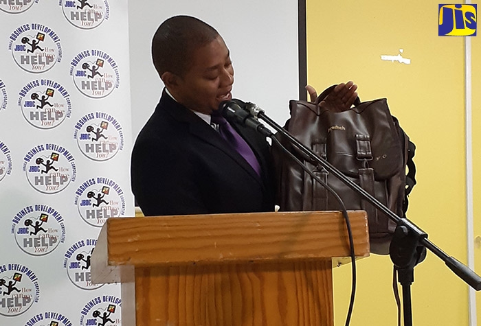 Minister of State in the Ministry of Industry, Commerce, Agriculture and Fisheries, Hon. Floyd Green, displays his custom-made bag from local small business, Bresheh, which is now a part of the Jamaica Promotions Corporation