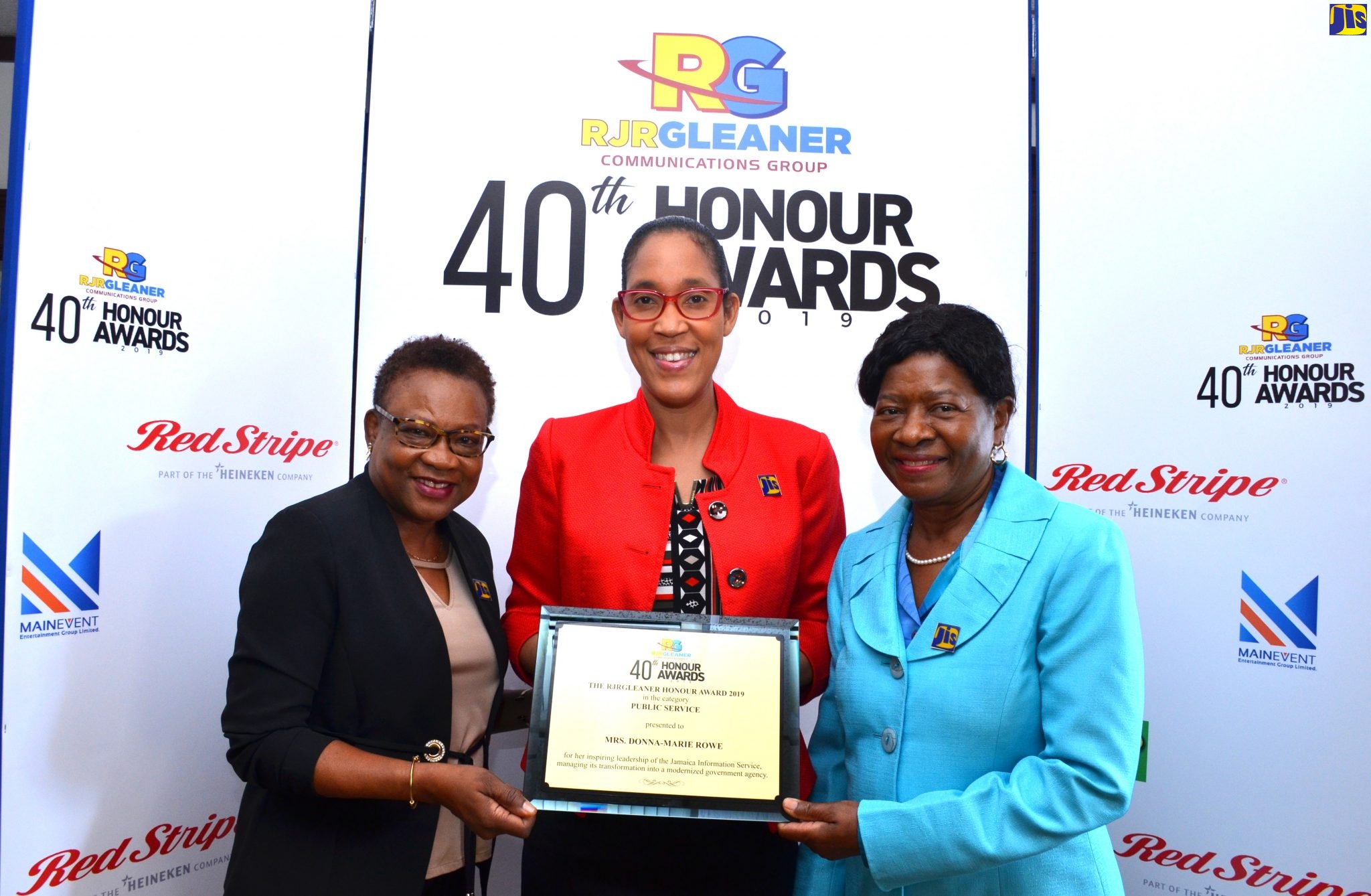 Chief Executive Officer, Jamaica Information Service (JIS), Donna-Marie Rowe (centre), displays her ‘Public Service’ award at the RJRGleaner Honour Awards Category Luncheon, held at The Gleaner Company in downtown Kingston, on Thursday (January 30).  Flanking her are Acting Deputy Chief Executive Officer, JIS, Enthrose Campbell (left); and Director, Human Resources, JIS, Bernita Locke.