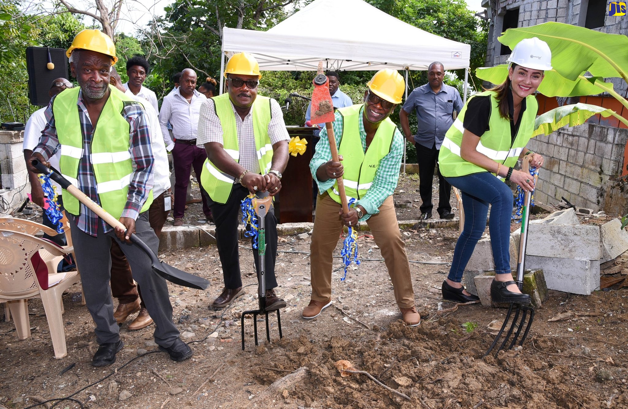 Minister of Local Government and Community Development, Hon. Desmond McKenzie (second right), breaks ground for the construction of a house for a needy family in Anchovy, Portland, on Tuesday (January 7). Others (from left) are Councillor for the Port Antonio Division, Dexter Rowland; Mayor of Port Antonio, Councillor Paul Thompson; and Member of Parliament for Eastern Portland, Ann-Marie Vaz.