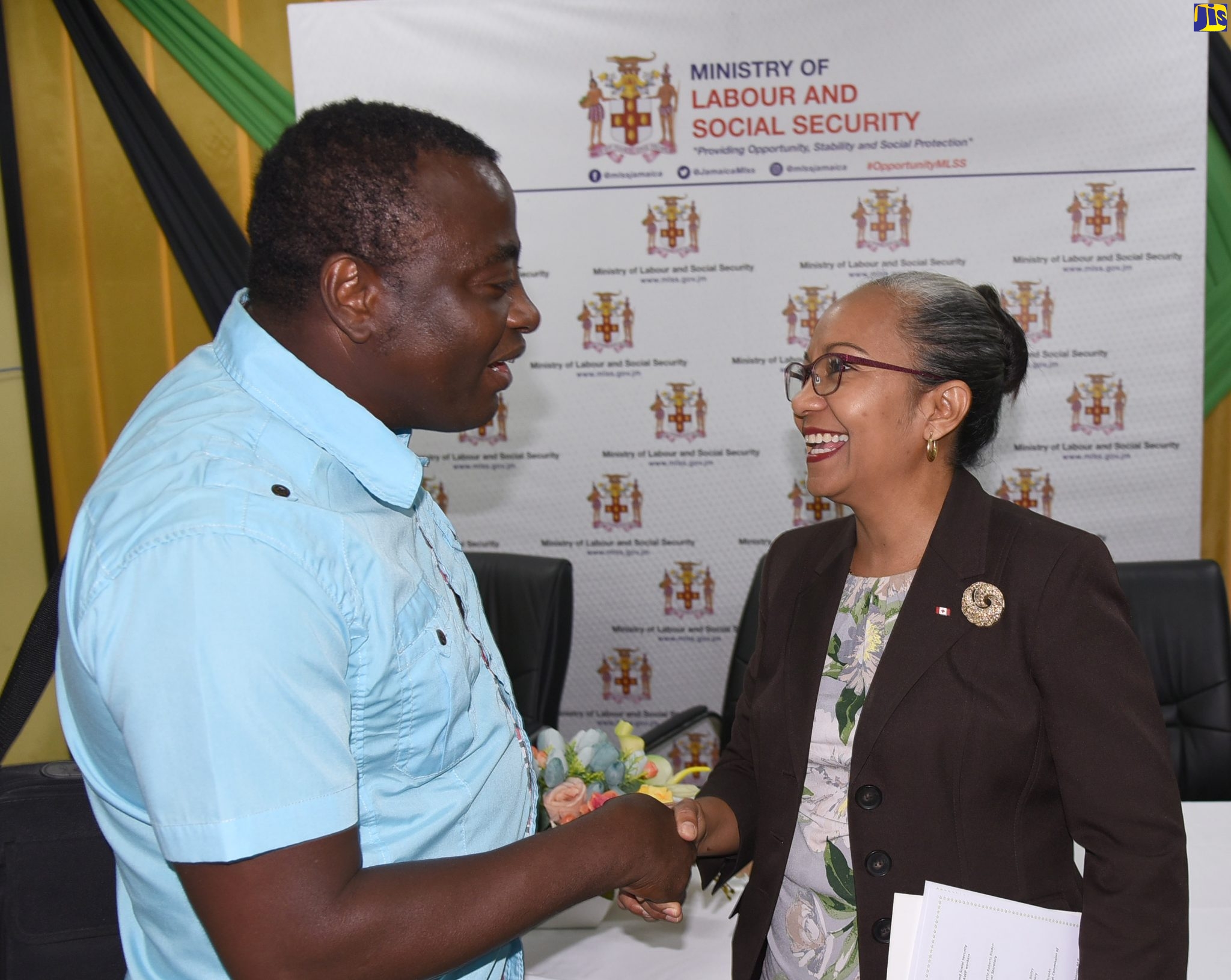 Permanent Secretary in the Ministry of Labour and Social Security, Colette Roberts Risden (right), engages in a light moment with the longest participant in the Seasonal Agricultural Workers Programme, George Blackwood, who has been travelling to Canada for job opportunities under the programme for over 20 years. Occasion was a send-off ceremony at the Ministry of Labour and Social Security’s Overseas Employment Services Centre on Friday (January 3). Mr. Blackwood is among 228 workers who will be leaving the island between now and Monday (January 6), to work in Canada.