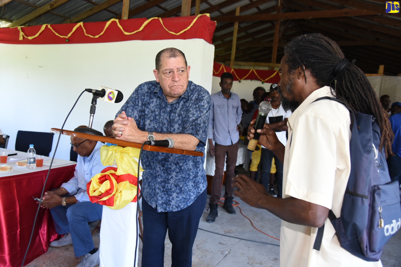 Minister of Industry, Commerce, Agriculture and Fisheries, Hon Audley Shaw (left) listens to Donovan Taylor (right), during a meeting with sugar-cane farmers previously employed by the Golden Grove Sugar Factory in St. Thomas. The meeting was held at the factory in Duckenfield, on Friday (January 24).