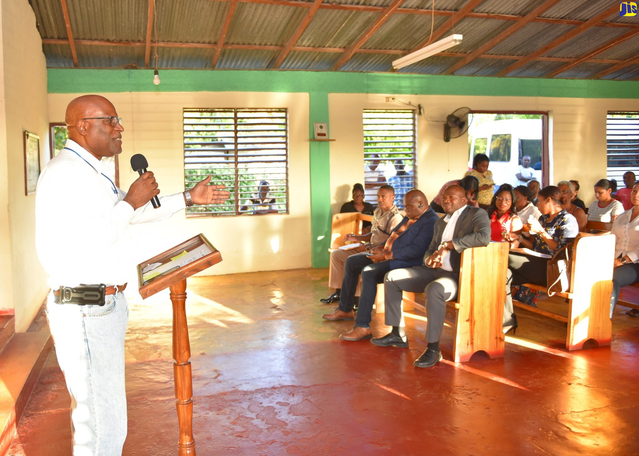 Lt. Col. Oscar Derby of the Vernamfield Development Project, in Clarendon, addresses residents about the project at a community meeting in Gimme-me-Bit, on January 15.
